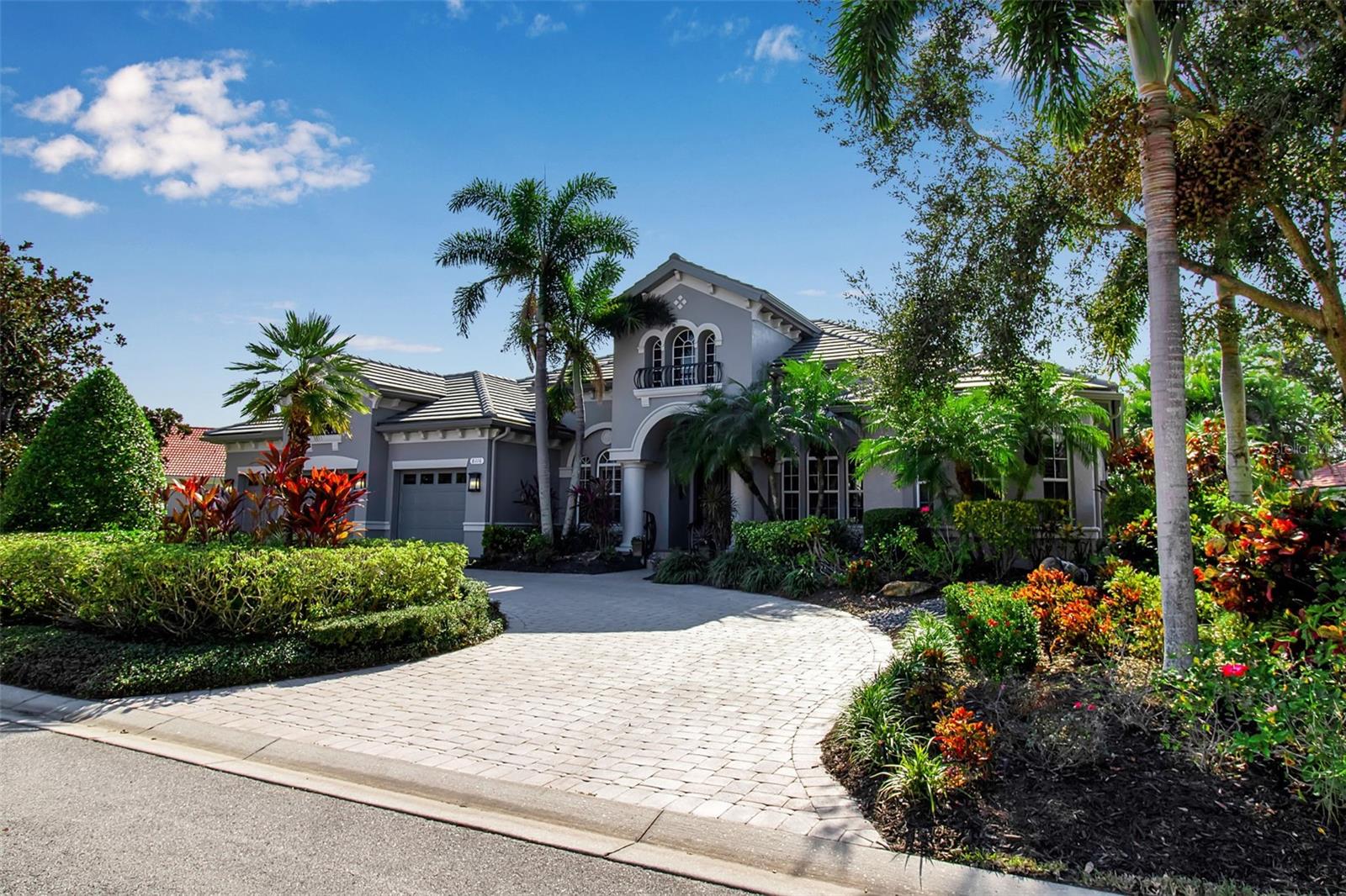 Situated on a private cul-de-sac within the highly desirable Canterbury neighborhood of Lakewood Ranch Country Club, this extensively updated residence offers nearly 3,850 square feet of thoughtfully designed living space, exceptional outdoor amenities, and a level of quality that is increasingly difficult to find.

From the moment you enter, soaring ceilings, abundant natural light, and an open, flowing floor plan create an inviting atmosphere ideal for both everyday living and entertaining. The fully renovated kitchen serves as the centerpiece of the home, featuring striking concrete countertops, premium appliances, wine refrigeration, professional ice maker, custom cabinetry, and generous gathering space for family and guests.

The spacious primary suite offers a true retreat, complete with a custom-designed walk-in closet and a beautifully remodeled spa-inspired bath featuring a luxurious steam shower. Three additional bedrooms, four full baths, and a flexible bonus room provide ample space for guests, a home office, fitness room, or media room.

Designed with comfort and convenience in mind, the home is equipped with integrated Sonos surround sound, centralized lighting controls, custom built-ins, and numerous thoughtful upgrades throughout.

One of the property's most exceptional features is the spectacular outdoor living environment. Designed and installed by renowned pool designer Lucas Lagoons, the lush tropical setting showcases a resort-style pool and grotto that transforms the backyard into a private oasis. An expansive lanai and fully equipped outdoor kitchen create the perfect setting for al fresco dining, entertaining, and embracing Florida's year-round indoor-outdoor lifestyle.

Significant recent improvements provide exceptional value and peace of mind, including a new roof, fresh exterior paint, whole-house generator, and numerous updates throughout the home.

Located behind the gates of Lakewood Ranch Country Club, residents enjoy access to an unparalleled lifestyle with championship golf, tennis, fitness amenities, dining, and miles of beautifully maintained grounds, all just minutes from University Town Center, Waterside Place, downtown Sarasota, and the Gulf Coast's renowned beaches.

Combining timeless architecture, extensive updates, resort-style outdoor living, and one of the community's most impressive custom pool environments, this move-in-ready Canterbury residence represents a rare opportunity in one of Lakewood Ranch's most established and sought-after neighborhoods.