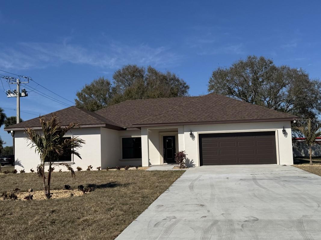 Under Construction. Brand New custom home!!! This home is near completion and available Mid February 2026. Pictures will be updated at completion. Conveniently located close to all the amenities Okeechobee has to offer. This home is not your typical home. This home features 1970 square feet under air, 2,580 square feet total, it is a 4-bedroom 2-bathroom home, the 4th bedroom is nearly the size of the master bedroom!! what makes this home so special? This home features custom finishes not found in your typical home, your typical home has wood baseboards and door moldings, here you will find beautiful CONCRETE 7 1/4" baseboards and 4" decorative concrete door moldings. you won't ever have to worry about water damage to these, you will NOT find this in any other home! it doesn't end there, step outside you will find the same beautiful concrete moldings and windowsills surrounding every window and door, a must see to appreciate! Other features include Granite countertops, a formal dining room, Porcelain wood look tile floors in the bathrooms, living room, and kitchen, with 3 bedrooms having upgraded carpet. The master bathroom features an oversized walk-in shower AND separate soaking tub beautifully decorated with Tile and concrete moldings, along with a 2-sink vanity. All closets feature beautiful all custom wood shelving, plenty of room for clothes!! The master closet even has a built in safe to protect all your valuables. For your heating and cooling you have a Heat pump system made by Trane. The home features custom impact resistant windows and Doors made by well know window manufacturer PGT. You have beautiful French doors with built in blinds that open up to a beautiful view of the overside back yard with a huge, beautiful oak tree to give you plenty of shade. Bring your pets, build your pool, there is plenty of space! This home also features and oversized 2 car garage, bring your oversized big truck inside!! Outside you will find the beautiful landscaping with Decorative steppingstones to compliment the grand entry. Some much to list, a must see to appreciate!!!