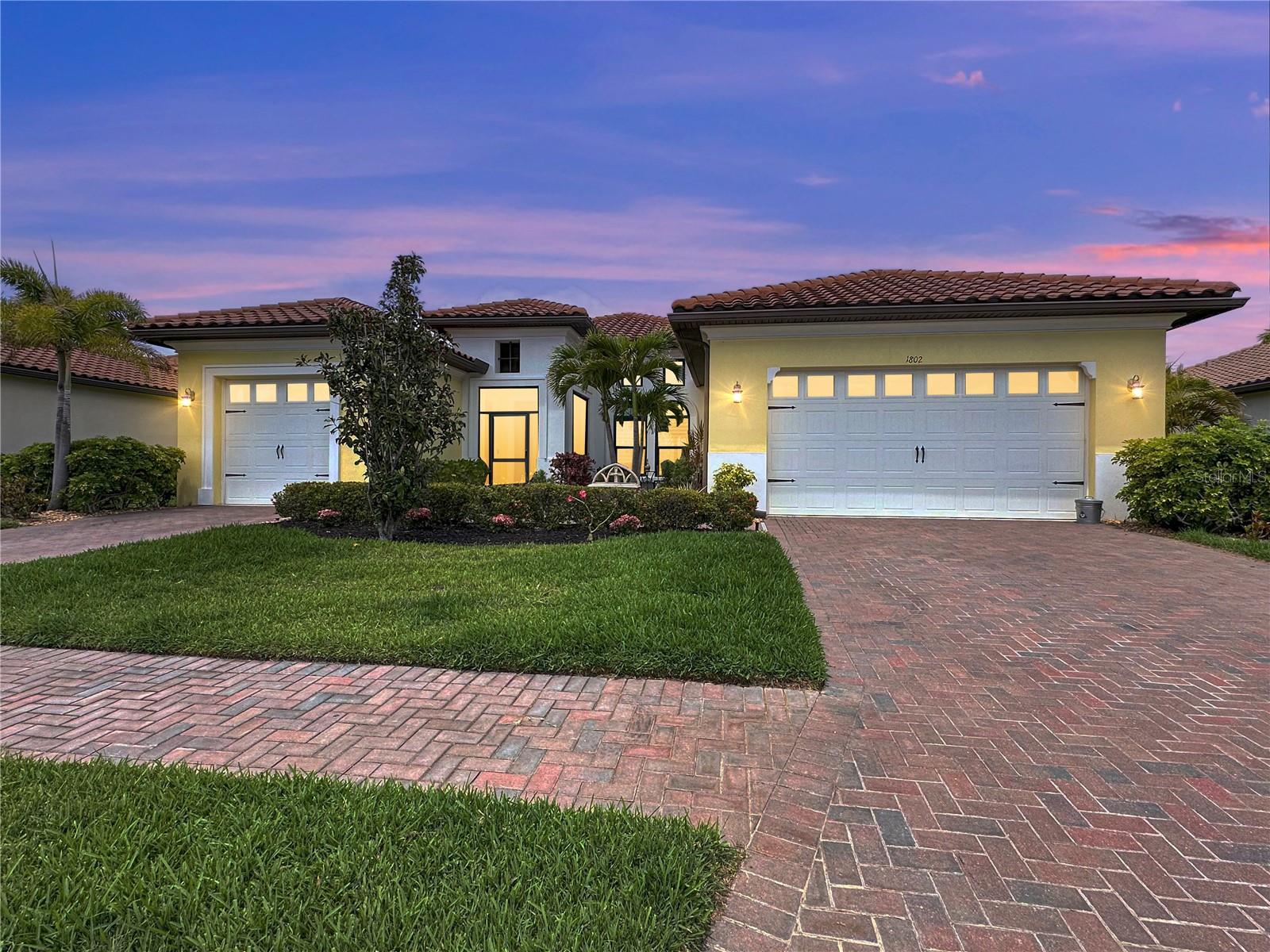 Welcome to this COASTAL DREAM HOME with DEEDED BOAT SLIP & LIFT located in the highly sought-after gated WATERFRONT BOATING COMMUNITY of Sanctuary Cove, perfectly positioned along the Manatee River in a NON-FLOOD ZONE with direct access to the Gulf of America. Offering the most sought-after floor plan (BORETTO) 4 bedrooms, and 3 bathrooms, this smart home combines luxury finishes, thoughtful design, and true Florida waterfront living. From the moment you arrive, you’ll notice the elevated curb appeal with a tile roof, paver driveway, 8-foot glass front entry door, and screened front entry that invites in the coastal breeze, especially with no neighbors across the street, enhancing privacy and openness. Inside, the spacious open-concept layout features luxury vinyl plank flooring, tall ceilings, crown molding, plantation shutters, and premium paint throughout. Architectural details include a coffered living room ceiling, tray ceilings, and a stunning Florida-style pecky cypress wood accent feature that adds warmth and character. The chef’s kitchen is designed for entertaining with GE Profile stainless steel appliances, including a natural gas cooktop, double wall ovens, brand-new dishwasher, built-in refrigerator, quartz countertops, two-tone cabinetry (coastal gray and white island), upper cabinet lighting, and a custom beverage station with dual-zone wine storage. This desirable 3 -way split floor plan offers privacy for all. The primary suite is a luxurious retreat featuring a pecky cypress foyer, dual vanities, soaking Jacuzzi tub with jets, oversized walk-in shower with glass doors, marble basketweave flooring, and a spacious walk-in closet with custom California Closet systems. Three additional bedrooms are thoughtfully positioned, including a guest suite with its own bath and a flexible pool bath layout perfect for visitors and entertaining. The outdoor living space is truly exceptional. Step through the pocket sliding doors into your private screened lanai featuring a heated pool, oversized spa with fountain feature, and a ELEVATED outdoor kitchen with fantasy brown leather granite countertops. This space is ideal for year-round entertaining and Florida sunshine living. Additional upgrades include a spacious 3-car garage with custom built-in cabinetry, Samsung washer and dryer in a large laundry room with quartz folding counters, built-in storage, and a utility sink. Smart home features include WiFi-enabled lighting, outlets, switches, a Honeywell smart thermostat, built-in security system, and a smart video doorbell. This home also includes DEEDED BOAT SLIP #29 in the community marina, complete with water and electric, and a boat lift accommodating vessels up to 31 feet, offering direct deepwater access to the Gulf of America. Sanctuary Cove delivers an unmatched resort lifestyle with amenities including a beautiful clubhouse, heated pool and spa, fitness center, marina, beach and nature preserve, and vibrant community events such as holiday golf cart parades and seasonal gatherings. Lawn maintenance, trimming, and irrigation services are included for easy living. Conveniently located just minutes from I-75 and I-275, this home provides easy access to St. Petersburg, Tampa, Bradenton, and Sarasota, as well as nearby shopping and dining, including the FAMOUS Detwiler’s Market. This is more than a home. It’s a WATERFRONT LIFESTYLE. Luxury, location, and boating convenience all come together in one extraordinary property.