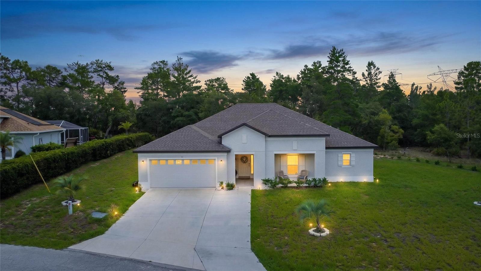 Nestled on a quiet cul-de-sac in the highly sought out Sugarmill Woods golf and country club community, this stunning 2024-built home delivers modern luxury from the moment you arrive. A large front porch invites you to sit and unwind, while an extra-wide driveway and 2-car garage set the tone for the quality that awaits inside.

Step through the entry into a huge foyer that welcomes you into an open-concept living space designed for effortless style and comfort. High ceilings throughout create an airy, spacious feel, while sleek luxury vinyl flooring flows seamlessly across the entire home, paired with granite countertops in every space that calls for them — from the kitchen to the bathrooms. The kitchen impresses with sleek appliances and a breakfast bar, perfect for casual mornings or entertaining guests.

The living area centers around a beautiful fireplace, while elegant plantation shutters adorn every room, adding warmth and sophistication throughout the home. With 4 bedrooms and 2 bathrooms across 2,291 square feet, there's abundant space for family, guests, or a home office — complemented by large walk-in closets offering exceptional storage. The primary bathroom features a double sink vanity, adding everyday convenience and a touch of spa-like luxury to your morning routine.

Extend your living outdoors on the expansive extended lanai, where peaceful greenbelt views create a natural setting. It's an ideal setting for morning coffee, evening relaxation, or entertaining.

Modern construction, thoughtful design, and an unbeatable location backing up to green space — this Sugarmill Woods gem is ready to welcome you home.