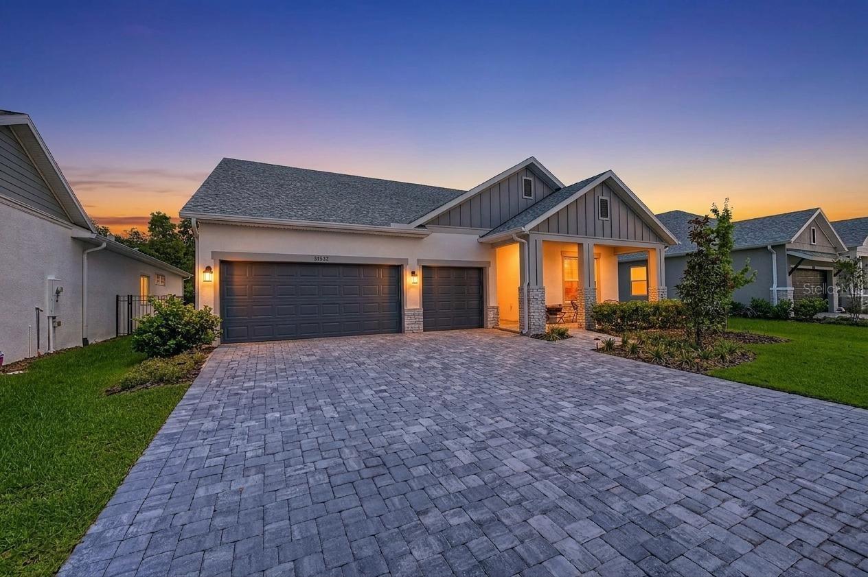 Experience the perfect blend of modern luxury and thoughtful design in this stunning 2025 David Weekley Home floor plan. This spacious 4-bedroom, 3-bathroom home also features a dedicated office, making it ideal for working from home or creating a flexible living space.

Designed with comfort and style in mind, the private fourth bedroom includes its own en-suite bathroom, making it perfect for guests or multi-generational living. Luxury vinyl plank flooring flows throughout the main living areas, while tile enhances all wet areas for beauty and durability.

The heart of the home is the chef-inspired kitchen, featuring an oversized center island, elegant quartz countertops, and an open layout that seamlessly connects to the living and dining spaces—perfect for entertaining.

Step outside to enjoy peaceful conservation views from the backyard, offering added privacy and a serene natural setting. A brick paver driveway enhances the home's curb appeal, while the 2025 construction provides the benefits of modern energy efficiency and today's most desirable finishes.

Don't miss the opportunity to own this beautifully designed, move-in-ready home that combines luxury, functionality, and an exceptional location.