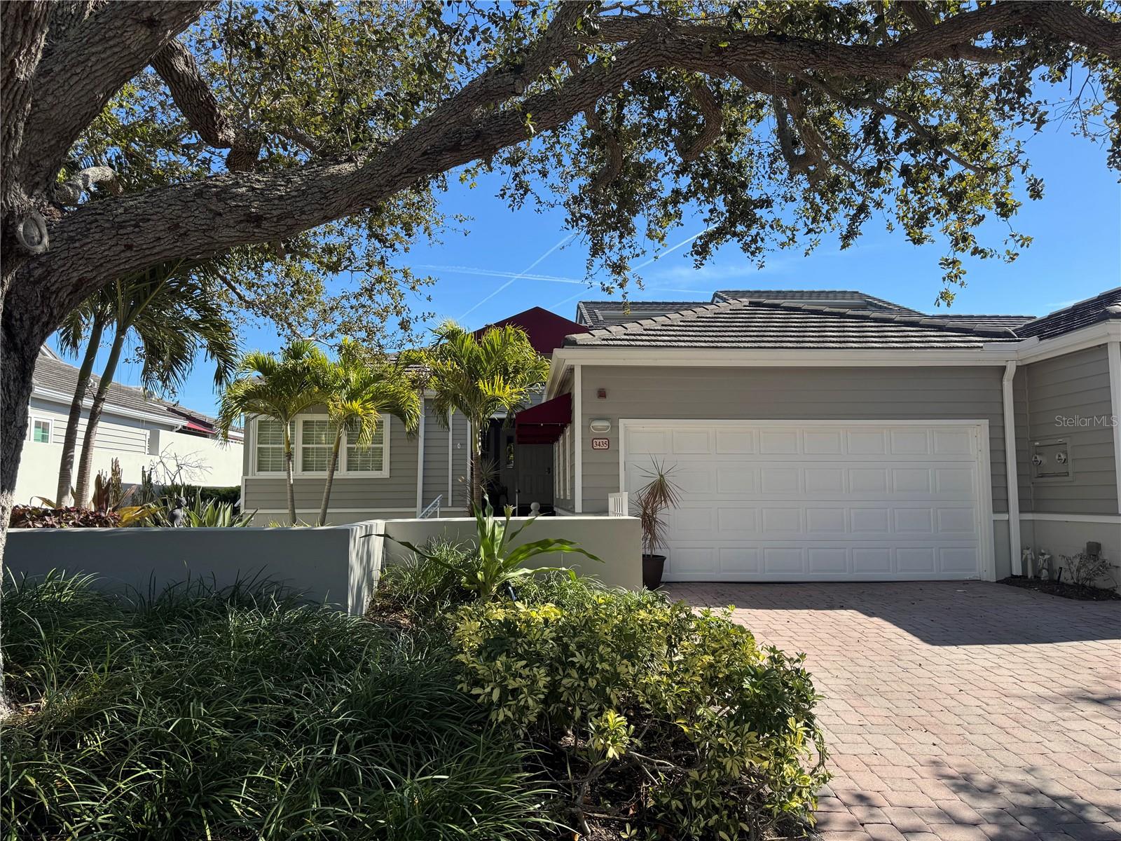 Own your own slice of tropical paradise on Longboat Key with this beautiful two bedroom  two and on half bath Villa in the exclusive  Winding Oaks Community located behind the gates of Bay Isles Association. Sweeping views of the Longboat Key Club Harbourside Golf Course and a sparkling inland waterway from your primary bedroom and expansive living/dining room combo that both exit through sliders to a fully enclosed wrap around deck to further enhance your tropical lifestyle.   Open floor plan with soaring ceilings and enclosed atrium help to maximize the natural light and make the 2,555 sq feet feel even larger.   

Beautifully updated eat in kitchen with striking tray ceiling, ample pantry storage,  bright white cabinets, quartz countertops and stainless steel appliances.

Primary owners suite includes an designer walk in closet, updated bath with ceramic tile, walk in shower, double sinks and quartz counter tops.   
Split layout offers a private guest suite, with walk in closet, updated ensuite bathroom with ceramic tile, walk in shower and quartz counter tops. Large office with desk nook could easily be converted to another bedroom. Laundry room with storage and sink adjacent to large 2 car garage with epoxy floors and storage cabinets.

Meticulously maintained, Impact Windows and sliders throughout, low maintenance mature plantings in private enclosed front courtyard.

Dog friendly community.  Beautiful updated community pool with bathrooms. Beach access via Bay Isles Beach Club which offers a private pavilion with bathrooms, volleyball, picnic tables, grills and ample parking.  Low maintenance community where all exteriors and court yards are maintained by the association.

Conveniently located mid key, one mile from Publix and CVS and a short drive to the restaurants and shops of St Armand’s and Downtown Sarasota.