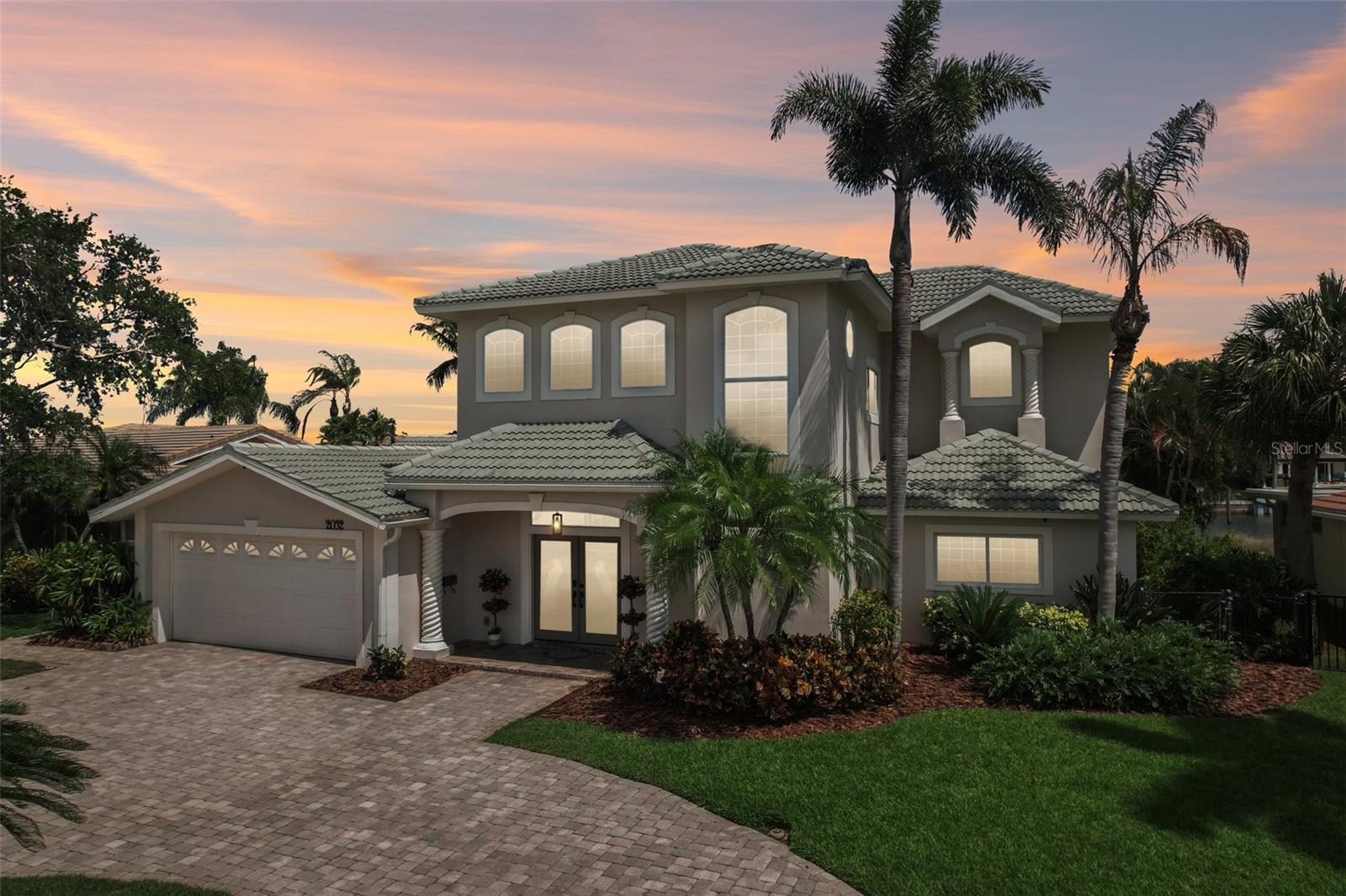 Welcome to 2032 Massachusetts Ave NE—a rare waterfront retreat where luxury living meets the ultimate Florida boating lifestyle. This stunning Mediterranean-style residence offers 5 bedrooms, 3 full bathrooms, a large 2-car garage, and direct deep sailboat water access with no bridges to Tampa Bay or the Gulf. Enjoy breathtaking panoramic water views, downtown St. Petersburg skyline views, unforgettable sunrises and moonrises, and front-row seats to seasonal fireworks displays from the expansive upstairs master suite veranda.
Designed for entertaining and everyday comfort, the heart of the home is the show-stopping chef’s kitchen featuring stunning quartzite natural stone countertops, an oversized 8-foot island with dramatic 4-inch quartzite waterfall edges, solid wood cabinetry, a pantry, and all-new smart stainless-steel appliances. Culinary enthusiasts will appreciate the induction cooktop, two full-size ovens, a microwave/convection combo serving as a third oven, two dishwashers, a built-in ice maker, a beverage/wine cooler, and a beverage center with its own sink and built-in wine rack. The space is anchored by two separate workstation sinks complete with integrated strainers, cutting boards, and drying racks, including a 36-inch oversized apron-front main sink. A dedicated dispenser provides reverse osmosis filtered, re-mineralized, oxygenated, and UV-sterilized water for healthy hydration.
The kitchen seamlessly flows into multiple spacious living areas with counter seating for 8, all perfectly positioned to capture sparkling water views often filled with manatees and dolphins. Gorgeous large-format 4x4 foot tile flooring spans the entire downstairs living space, beautifully illuminated by smart lighting and a sleek electric fireplace. The first floor offers a desirable split-bedroom layout with four spacious bedrooms and two full baths, perfect for family or guests.
Occupying the entire second floor, the luxurious owner’s retreat feels like a private sanctuary. Brazilian Cherry hardwood floors, abundant natural light, a loft office and sitting area, two separate walk-in closets, a gas fireplace, two granite vanities, a seamless glass shower, a private water closet, and a two-person jetted spa tub create a true resort-style experience. Step outside to the enormous 600-square-foot master suite veranda featuring both covered and open-air spaces. It is the perfect setting for morning coffee, evening cocktails, downtown skyline views, and watching fireworks light up the St. Pete sky.
Outside, the tropical backyard is designed for year-round enjoyment and privacy, featuring a heated saltwater pool, expansive paver decking, and multiple entertaining spaces. The dock features a boat lift plus a second lift designed for two jet skis or additional water toys like kayaks and paddleboards. Dolphins and manatees frequently visit the protected, sailboat-accessible waters behind the home, creating a true coastal paradise.
Additional upgrades and high-end highlights include smart appliances, smart light switches, smart locks, recessed lighting throughout, a custom garage with epoxy floors and built-in cabinetry, gym mirrors, and tropical privacy landscaping. Located on a quiet cul-de-sac street just a short bike ride or boat ride to vibrant downtown St. Petersburg and nearby Weedon Island Preserve, this exceptional waterfront property delivers luxury coastal living at its finest.