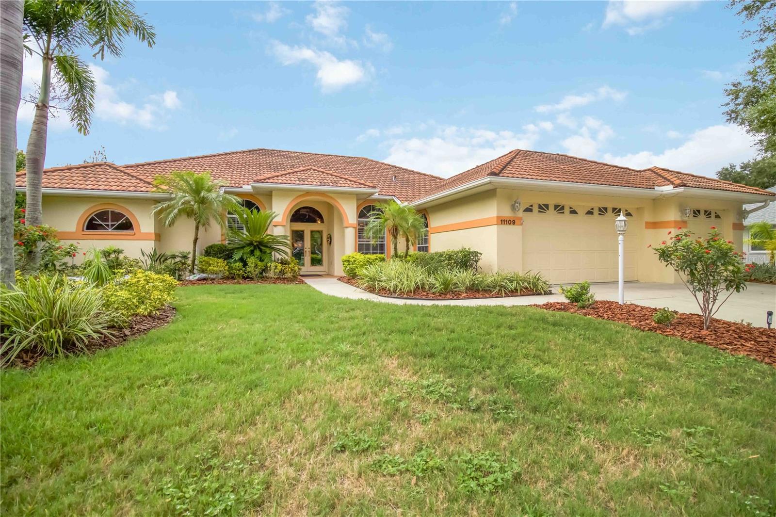 Nestled on a peaceful lakefront homesite in River Woods, this custom built executive pool home offers the perfect blend of privacy, comfort, and Florida outdoor living. Surrounded by mature tropical landscaping and beautiful water views, this thoughtfully designed residence features 4 bedrooms, 3 bathrooms, a dedicated office with French doors, and a desirable tri split floor plan that provides flexibility for family and guests.

A grand entry with custom Florida inspired stained glass doors welcomes you into the home, where soaring ceilings, abundant natural light, and expansive living spaces create an inviting atmosphere. The open layout includes formal and casual dining areas, a spacious great room, and an oversized kitchen with abundant cabinetry, generous counter space, a butler's pantry, and an aquarium window overlooking the pool and lanai.

The primary suite is a private retreat featuring direct access to the lanai, dual vanities, a garden tub, separate shower, and spacious walk in closets. A second guest suite offers an ideal setup for visitors or multigenerational living.

The outdoor living space has been extensively renovated and serves as the centerpiece of the home. Recent improvements include a resurfaced pool, updated pool tile, and beautiful new paver decking surrounding the pool and spa. The expansive screened lanai offers multiple covered seating areas, abundant deck space for entertaining, and tranquil lake views framed by lush tropical landscaping. Whether enjoying a quiet morning coffee or hosting family and friends, this outdoor oasis was designed to be enjoyed year round.

Additional features include a barrel tile roof, oversized 3 car garage, buried 250 gallon propane tank, outdoor shower, energy efficient features, and mature landscaping that enhances both beauty and privacy.

Located in the highly sought after River Woods community, residents enjoy access to a community pool, tennis courts, clubhouse, fitness center, and scenic walking areas, all with convenient access to I 75, Lakewood Ranch, shopping, dining, golf, and the Gulf Coast beaches.

This is a rare opportunity to own a beautifully maintained lakefront home with an exceptional outdoor living experience in one of Parrish's most established communities.