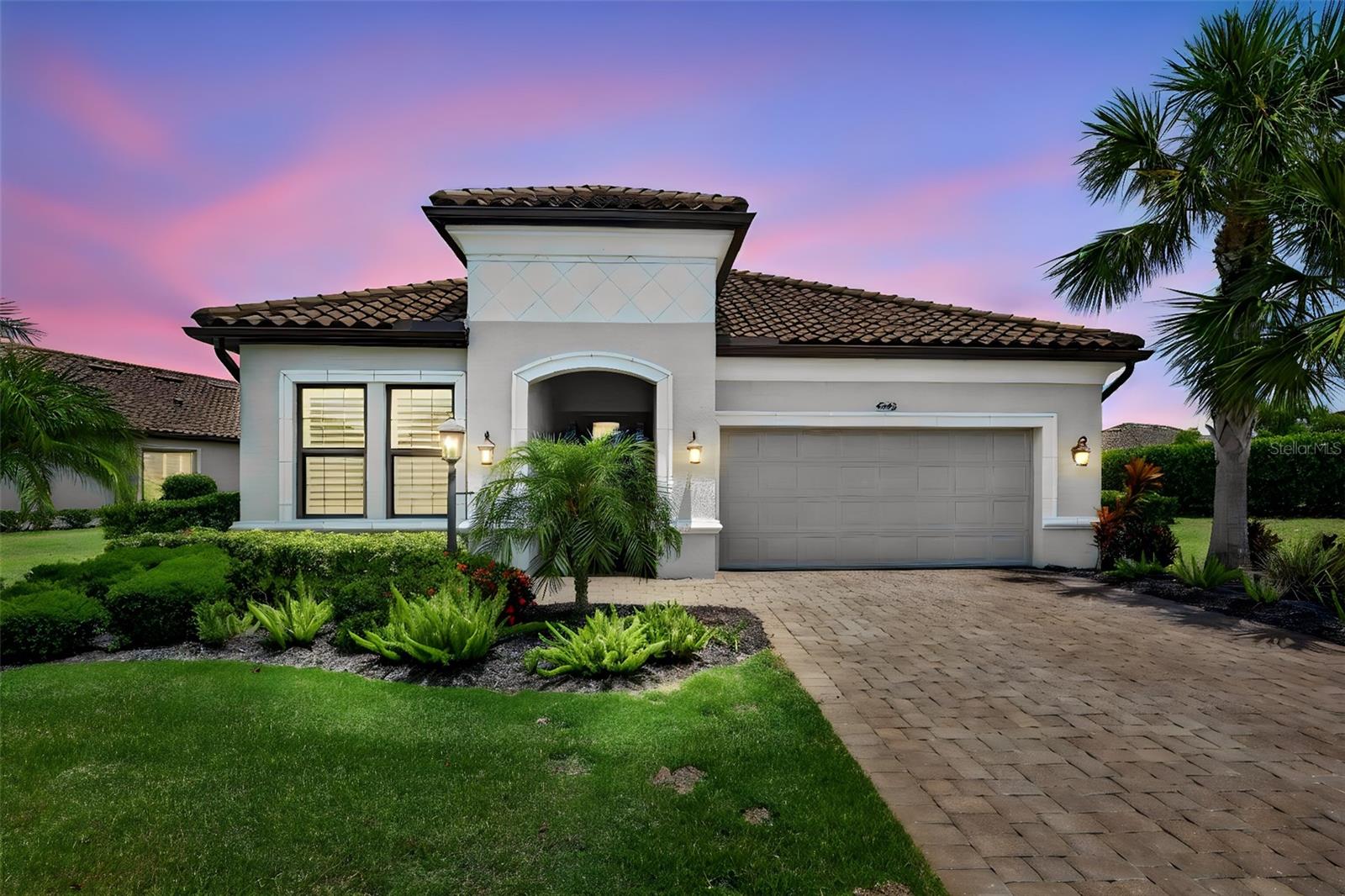 Welcome to an exceptional turnkey residence in the highly sought-after Esplanade Golf & Country Club, perfectly positioned on the 12th tee box with stunning golf course views that create a breathtaking backdrop for everyday living. This deeded golf property offers the ultimate in luxury and lifestyle on a desirable cul-de-sac.
This beautifully appointed 2-bedroom + den, 2.5 bath home showcases refined design and thoughtful upgrades throughout. From the moment you arrive, the custom glass front door sets the tone for the elegant interior, featuring tray ceilings, crown molding, and an open-concept layout designed for both comfort and entertaining.
The chef’s kitchen is a true centerpiece, complete with a designer backsplash, oversized island with additional storage, pull-out shelving in all base cabinets, and a spacious butler pantry offering abundant prep space. A custom-built wine display accommodating up to 30 bottles adds a sophisticated touch.
The versatile den/office is enhanced with built-ins, closet space, and a Murphy bed with twin beds, and could easily function as a third bedroom for added flexibility. The primary suite offers a private retreat with a custom closet featuring a locking jewelry drawer and convenient laundry room access.
Seamless indoor-outdoor living is achieved through corner pocket sliding doors that open to an expansive lanai finished with travertine flooring. The outdoor space is designed to impress, featuring an oversized island with built-in speakers, a summer kitchen with gas griddle, and a natural gas firepit table. Enjoy the saltwater pool with color-changing LED lighting, pop-up cleaning system, auto-fill, and a new pool heater and pump (2025). Croci hurricane impact shutters and privacy wind screens provide both comfort and peace of mind.
Additional highlights include plantation shutters, ADT security system, Ring doorbell, water sensors throughout, and a garage equipped with epoxy flooring and an electric overhead storage rack.
Experience the ultimate in amenity-rich, resort-style living in one of Lakewood Ranch’s premier communities, offering golf, dining, wellness, and an unparalleled lifestyle.

Living in Esplanade is like being on vacation every day. The community is built around healthy living and living well with unlimited exercise and social options. Esplanade offers a wide array of amenities and activities such as an 18-hole championship golf course, two resort pools, hot tubs, resistance pool, pickleball, tennis, bocce ball, two fitness centers, exercise classes, two dog parks, playground, firepit, spa/salon, an on-site lifestyle director, social events, and various clubs. The state-of-the-art Culinary Center offers residents several dining options such as the Barrel House Bistro, Bahama Bar, as well as catering services, wine tastings, and special events. Esplanade is located in the heart of Lakewood Ranch, close to I-75, Lakewood Ranch Main St., University Town Center, Sarasota Polo Club, shopping, dining, entertainment, hospitals, cultural attractions, boating, parks, and Florida’s famous sandy beaches. CONTENTS IN WINE CABINET DO NOT CONVEY.