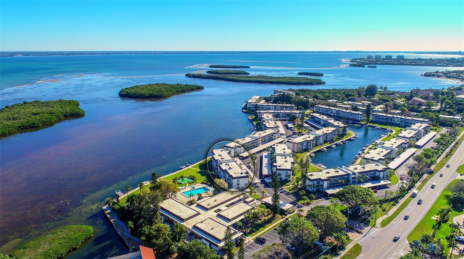 Motivated Seller, make an offer. Welcome to this beautifully updated top floor corner furnished residence with Gulf and Bay views that is move in ready. Coming furnished with an open kitchen floor plan and an enclosed lanai overlooking the pool and Sarasota Bay. Large plank ceramic tiles throughout and ceiling fans in every room, hurricane impact glass windows in the kitchen and living area and a washer/dryer has been added. All tv's within the residence stay. The Longboat Harbour community is located mid-Longboat Key with amenities to enjoy including a large clubhouse where many activities occur, with a catering kitchen and dance floor, art studio, billiard and card rooms, and a fully equipped fitness center. In addition, the community has four heated swimming pools, putting green, tennis and pickleball courts, kayak storage, boat slips available for a minimal annual fee for up to a 34’ boat, mini golf, a scenic waterfront promenade along the harbor and canal, and access to a private gated Beach Club on the Gulf side with bathrooms, showers and beach items. The building has just completed a new roof installed. There is additional storage withing the building for each residence as well as a storage closet on the enclosed lanai.