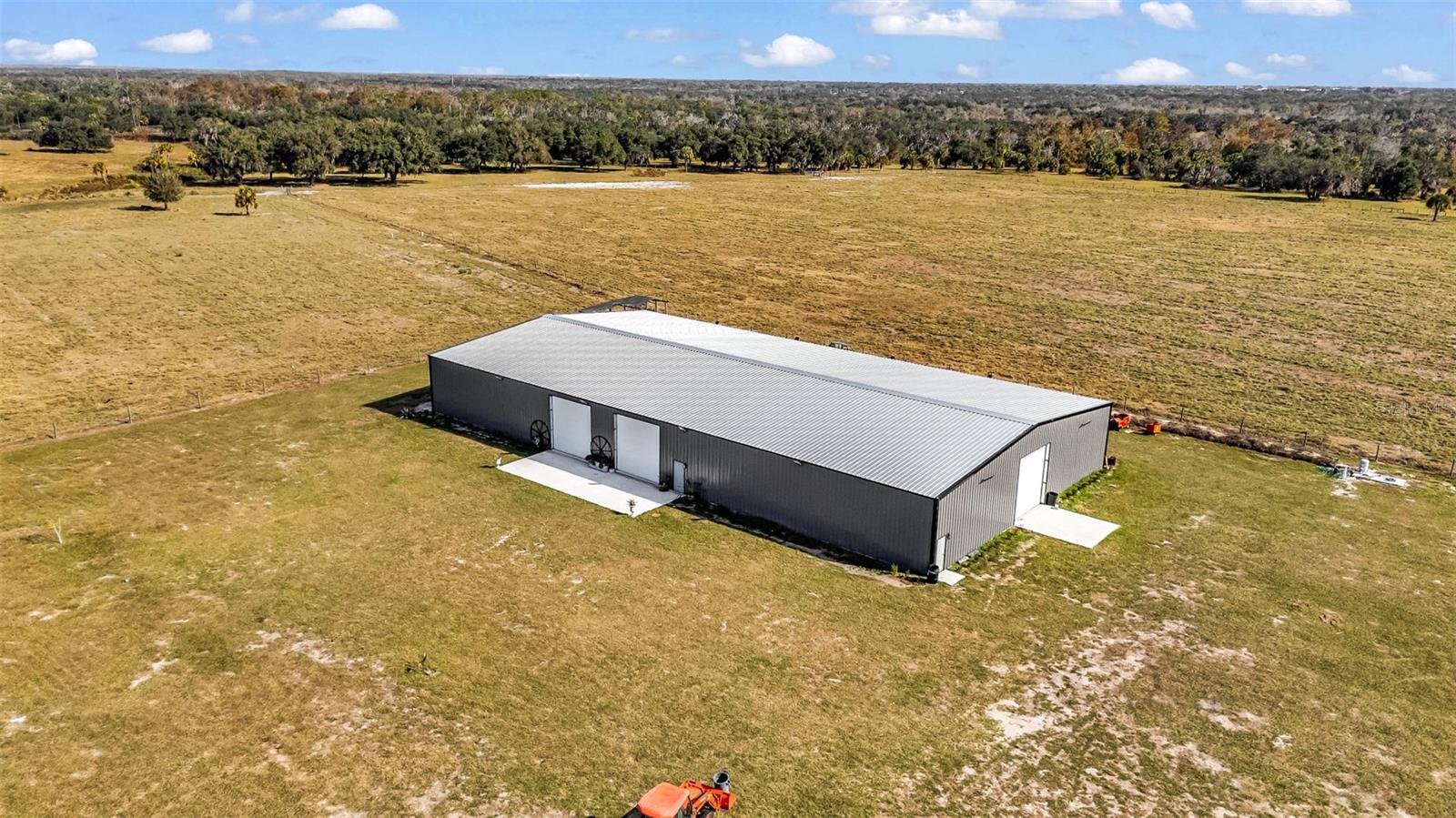 This outstanding 20-acre property offers a rare combination of usable pasture, quality infrastructure, and flexible potential. The land is entirely pasture with an attractive board double-gate entryway and is fully fenced and cross-fenced with barbed wire, making it ideal for livestock or agricultural operations. A private well provides reliable on-site water.

A standout feature of the property is the impressive 80’ x 150’ steel metal building, constructed on a 6” concrete slab. The building is fully air-conditioned and includes three large 14’ x 16’ roll-up chain hoist doors, offering excellent access and versatility for equipment, storage, or business use.

The property is comprised of two 10-acre parcels, allowing for future flexibility or the option to sell one parcel separately. With its strong infrastructure and open layout, this property is perfectly suited for an agricultural business, venue, or agri-event center, as well as a wide range of other commercial or investment opportunities.