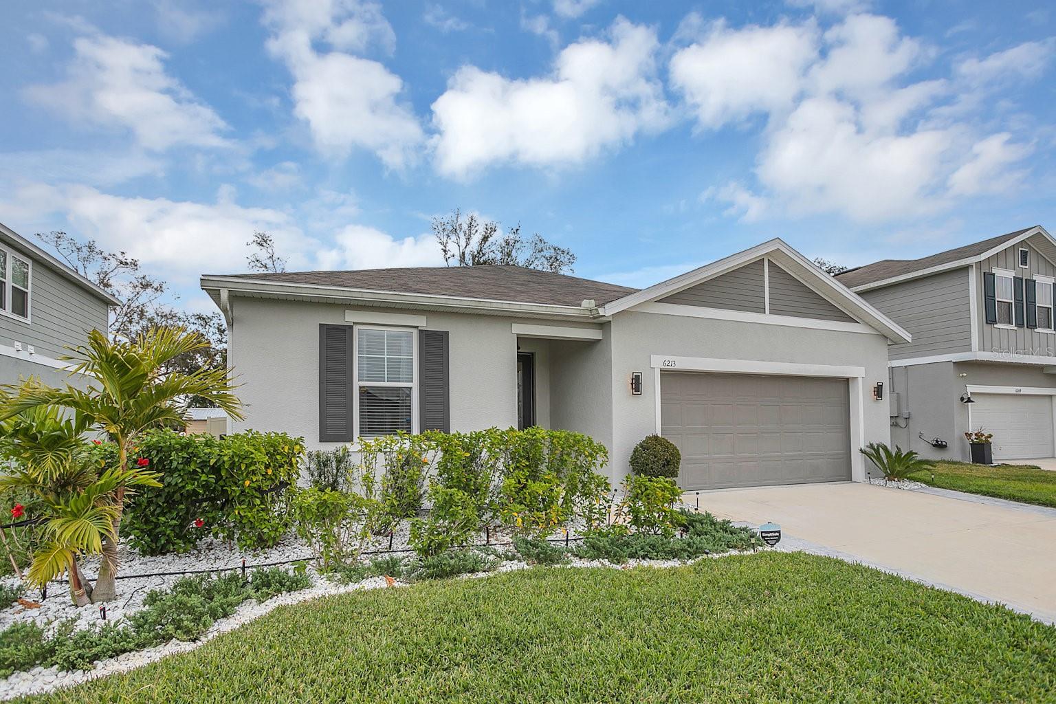 Are you searching for a luxurious home in South Lakeland built by Richmond American Homes? Look no further! This recently built 4-bedroom, 3-bathroom home features upgarded luxury floors, extra high ceilings, 8 ft doors, and exquisite finishes. The open floor plan with a fireplace creates the perfect space for family gatherings. Enjoy Florida's beautiful weather on your private extended porch and in the fully fenced yard. The professionally designed yard with brand new St Augustine grass in the front, as well as upgraded irrigation system to conserve water.  For your peace of mind, a low-maintenance, low-cost security system is already installed and paid off. The low HOA fee grants you access to a fantastic clubhouse and pools, without the hassle of upkeep. Great investment opportunity with low maintenance fee and easy rental income. Only 1 hour to the beach at the Gulf coast or 50 minutes to Disney parks makes it perfect for your investment. This flawless home won't last long. Call now to schedule a viewing!