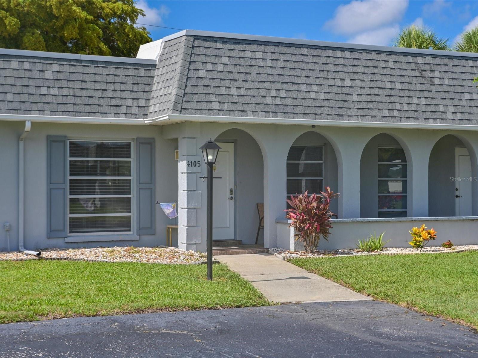 Welcome to Cortez villas, a well-maintained 55+ community in desirable West Bradenton. This beautifully updated single-level villa offers convenient front-door parking and excellent accessibility. Featuring 2 bedrooms, 2 baths, plus a den, this turnkey furnished condo showcases a completely renovated kitchen with Shaker cabinetry, quartz countertops and backsplash, stainless farmhouse sink, eat-in dining area and a side serving area with quartz top. Additional upgrades include laminate flooring throughout, fresh interior paint, updated ceiling fans, and an enclosed lanai with tile flooring and glass windows, creating valuable year-round living space. Both bathrooms have been tastefully updated, primary bath has a walk-in shower. Major improvements provide peace of mind, including a 2015 Carrier A/C system, 2018 water heater, and a newer roof, which helps reduce insurance costs. Enjoy a tranquil backyard setting with a large shade tree and direct access to the community clubhouse and heated pool. The lanai patio area is perfect for grilling (grill included) and outdoor relaxation. Ideally located near Publix, Target, Walmart, restaurants, banking, medical facilities, and just a short drive to the beautiful Gulf beaches. Move-in ready and maintenance-free Florida living at its best. Low monthly fee, $541.00 monthly, includes clubhouse, pool, common areas, water, sewer, trash, cable, internet, exterior insurance, and lawn care.