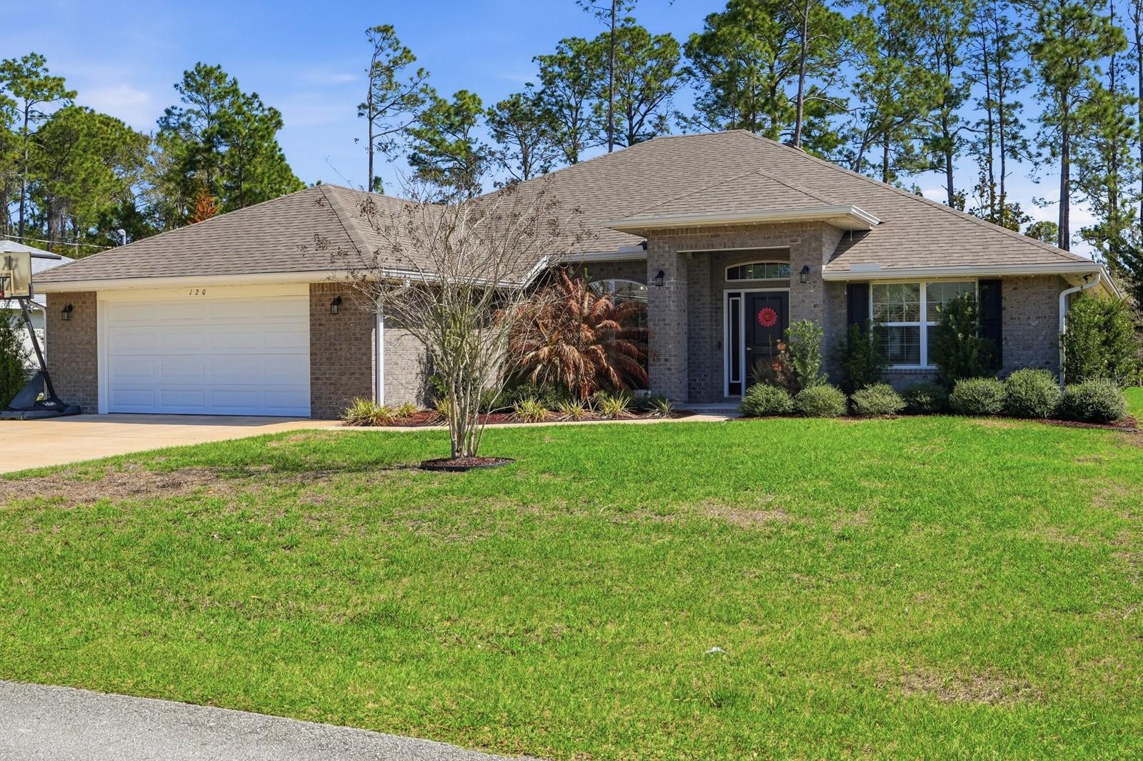 Welcome to this beautifully maintained 2021-built home in Palm Coast, offering modern finishes, a spacious open layout, and peaceful surroundings. Located on a quiet street at 120 Bren Mar Lane, this move-in-ready property combines comfort, style, and convenience. Step inside to find a bright and airy open-concept living space with soaring ceilings, recessed lighting, and durable luxury flooring throughout the main areas. The expansive living room flows seamlessly into the kitchen and dining area, creating the perfect setting for entertaining or everyday living. The well-appointed kitchen features rich cabinetry, stainless steel appliances, ample counter space, and a functional island with bar seating overlooking the dining area and backyard. Large windows fill the home with natural light while providing views of the private backyard. The spacious primary suite offers a relaxing retreat with a generous bedroom layout and a private bath. Additional bedrooms provide flexibility for guests, family, or a home office. This home was built in 2021, and the roof, HVAC system, and water heater were all installed that same year. The laundry room has been upgraded with new cabinets, adding extra storage and convenience. Fresh landscaping enhances the curb appeal, while modern finishes and neutral tones throughout the home create a clean and contemporary feel. The property also includes a two-car garage and a spacious driveway. Outside, the home sits on a nicely sized lot with a large backyard backing up to a peaceful wooded and water view, offering added privacy and a tranquil setting. Conveniently located near shopping, dining, schools, parks, and Palm Coast’s beautiful beaches, this home offers the perfect balance of quiet living and easy access to everything the area has to offer. Don’t miss your opportunity to own this nearly new Palm Coast home, schedule your showing today!