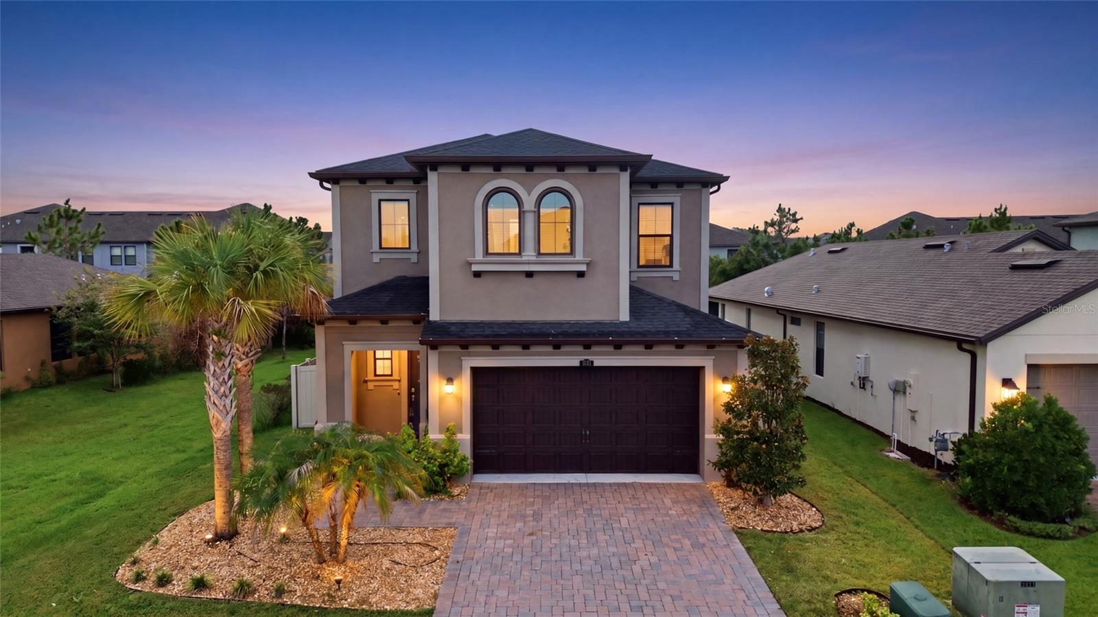 Welcome to this exceptional Hutchinson floor plan in the highly sought-after Estancia at Wiregrass, where luxury, thoughtful design, and everyday comfort come together. Offering 4 bedrooms, 3 full bathrooms, a private office, a spacious loft, and 3,176 square feet of beautifully designed living space, this meticulously maintained home also features custom-built closets in every bedroom and a Tesla charging station, making it perfectly suited for today's lifestyle. Step inside to a bright, open-concept floor plan filled with natural light, elegant finishes, and carefully curated upgrades. The first floor features a private guest bedroom and full bathroom, ideal for visitors or multigenerational living, along with a dedicated office that creates the perfect work-from-home space or quiet retreat. At the heart of the home, the gourmet kitchen is designed to impress, showcasing modern appliances, a water filtration system, abundant cabinetry, generous counter space, and an oversized center island that seamlessly connects to the expansive great room—creating the perfect space for entertaining or everyday living. Adjacent to the kitchen, the formal dining room offers an elegant setting for family gatherings and special occasions. Upstairs, the luxurious owner's suite serves as a private retreat, complete with a sitting area ideal for reading, relaxing, or enjoying your morning coffee. The spa-inspired ensuite bathroom and oversized walk-in closet with custom-built organization add both comfort and sophistication. Every bedroom throughout the home has been enhanced with custom closet systems, providing exceptional storage and organization. Two additional bedrooms, another full bathroom, and the expansive loft provides incredible flexibility for a media room, game room, fitness area, playroom, or second family room. Step outside to enjoy Florida living year-round from the screened and enclosed lanai, creating the perfect outdoor space to relax or entertain in every season. The spacious backyard provides endless possibilities for outdoor dining, pets, play, or designing your own private backyard oasis. As a resident of Estancia at Wiregrass, you'll enjoy world-class amenities including a resort-style clubhouse, swimming pool, tennis and pickleball courts, basketball courts, scenic walking trails, parks, playgrounds, and a vibrant calendar of community events.
Conveniently located near top-rated schools, AdventHealth Wesley Chapel, BayCare Hospital, Tampa Premium Outlets, The Shops at Wiregrass, KRATE at The Grove, countless dining and entertainment options, and with quick access to I-75 and I-275, this home delivers the perfect combination of luxury, convenience, and location. Don't miss this rare opportunity to own one of Estancia's most desirable floor plans. Schedule your private showing today and experience everything this exceptional home has.