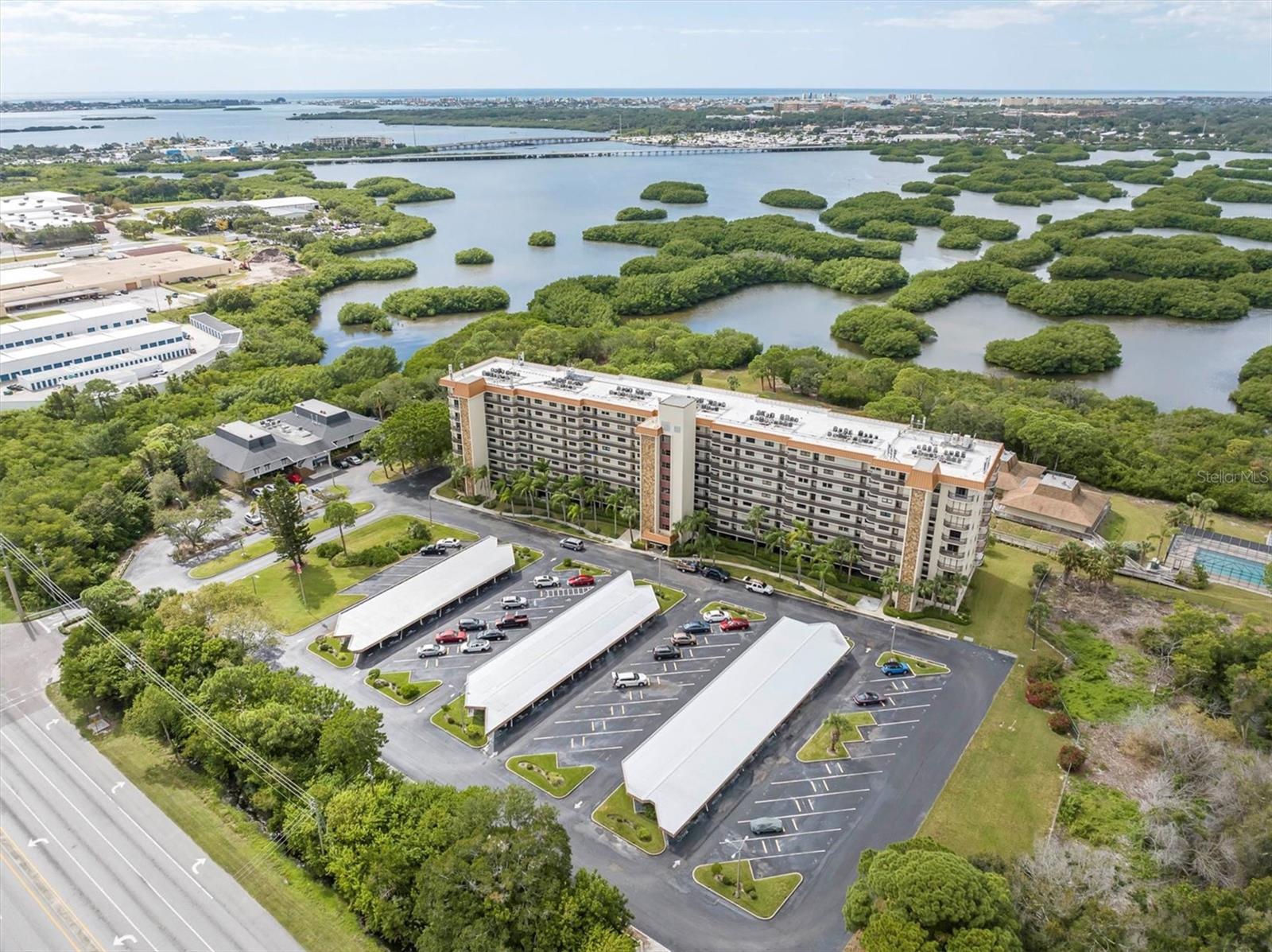 SUPERB LOCATION + LARGE UPDATED CONDO + IN-UNIT LAUNDRY + CARPORT = PERFECTION IN PARADISE! Welcome to Otter Key, a highly desirable waterfront community on Cross Bayou in Seminole, FL! This clean-as-a-whistle, 2 bedroom 2 bath condo with relaxing wooded views is sure to delight! As you walk in the front door, your eyes can't help but to be drawn to the UPDATED (2020) kitchen featuring GRANITE COUNTERS, wood cabinetry, STAINLESS STEEL APPLIANCES, ceramic tile floors and a GAS RANGE!!! Just off the kitchen is a convenient BONUS ROOM that can serve as an in-home office, den, library or sitting room. Carry on to the open-concept dining and living room and enjoy this expansive space which is sure to be a highlight of your new home. The LARGE main bedroom has a WALK-IN CLOSET and recently updated (2020) ENSUITE BATHROOM boasting a STEP-IN SHOWER, contemporary vanity with granite countertop. The spacious guest bedroom and bathroom with tub/tile shower are on the opposite side of the condo allowing privacy and convenience. The SCREENED PATIO is the perfect place to relax while sipping your morning coffee at sunrise, read a book or simply take in the sounds of nature with your evening meal. This condo has many upgrades and features, some of which include: Upgraded kitchen (2022), ceiling fans (2020), hurricane impact windows (2023), stainless steel appliances (2020), flooring (2020), and carport. ~As an added bonus to this community, the roof, hot water heater, internet, cable, water/sewer and MORE is paid for by the Association! Otter Creek is RESORT STYLE LIVING including an abundance of activities with no additional fees.  Included is a boardwalk through a wooded oasis leading you to TENNIS COURTS, PICKLE BALL COURTS, HEATED POOL, SAUNA, SUNNING DECK, EXERCISE ROOM, BILLIARDS, CLUBHOUSE, KITCHEN, ACTIVITY ROOM, AND PATIO WITH GRILL.~ Otter Creek is perfectly located within a short drive to the GULF OF MEXICO beaches, shops, restaurants, downtown St Petersburg and more. Don't delay or this one will be gone!