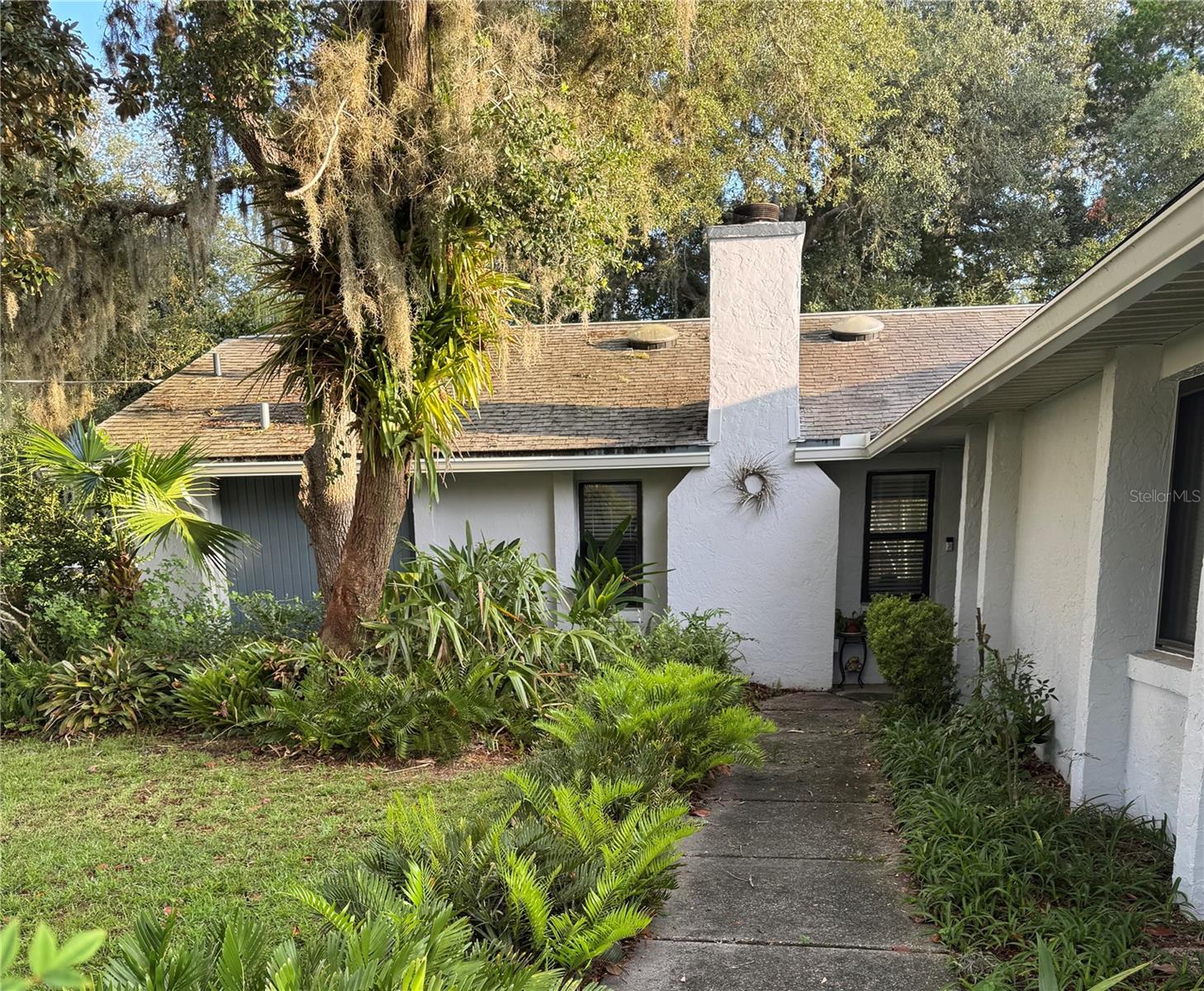 This bright and cozy bungalow will steal your heart.  Centrally located and nestled in a park like setting, this 2/2/2 home is unique to the area.  The numerous skylights and stack sliding glass doors bring the outdoors in and the wood burning fireplace and luxury vinyl flooring throughout are added bonuses.  This little gem (just over 1300 square feet) is only minutes away from shopping and the beach.