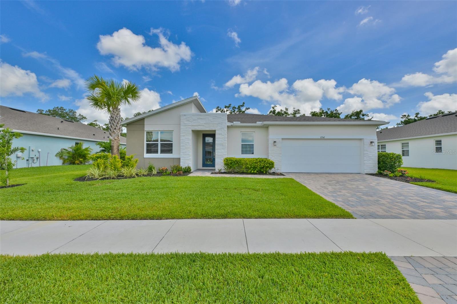 Nearly new, gorgeously upgraded Red Rock Contemporary plan, on an 80 by 140 ft. lot with a conservation-like back yard view, is ready for you in the gated community of Windwater in Parrish! No flood insurance is required and NO additional CDD fees! This 3,056 sq. ft. beauty has 4 bedrooms, 3.5 baths, an oversized family room and large flex/game room with French Doors. The plan includes a study/den/office, a separate dining room with board and batten walls, stunning executive chef's kitchen with quartz countertops, 36" five burner glass cooktop with deluxe outside vented hood, stainless steel appliances, large island with single bowl stainless sink, breakfast bar, pendant lighting and an oversized walk-in pantry. Primary bedroom has a tray ceiling, double walk-in closets, stunning large shower with glass doors, niches and listello accents, double vanities and a separate water closet. The entire house is totally upgraded with crown molding, top of the line porcelain tile (18"x18") with sealed grout and quarter-round trim, casings around every window, additional recessed lighting, extra electrical outlets, linen closets in all 3 full bathrooms, ceiling fan pre-wires in every room and woven wooden shades in all windows! Additional items for the energy conscious buyer include spray foam insulated exterior cinder block walls, insulated hurricane proof garage door, irrigation system around entire house that uses reclaimed water, gutters on all sides of home, whole home dehumidifier tied to the HVAC system and two RO water systems, one for the kitchen sink and one for the refrigerator ice maker!  The huge laundry room includes a utility sink set into a large cabinet with quartz countertop and cabinets over the included full-size Electrolux washer and dryer on bases bought new with the house in 2024. A 3 car tandem garage with epoxy painted floor, pull-down attic access stairs in garage, pavered driveway, pavered screened lanai, keyless entry, security alarm, Ring doorbell, Ecobee thermostat, 8 ft. interior doors, 8ft. glass front door, double-paned vinyl clad tilt-out windows and beautiful landscaping add even more features and benefits to this one of a kind home!  Seller providing a home warranty to the the new owner for peace of mind!  Be sure to click on the video of home and neighborhood to appreciate this rare beauty and all the amenities Windwater has to offer!