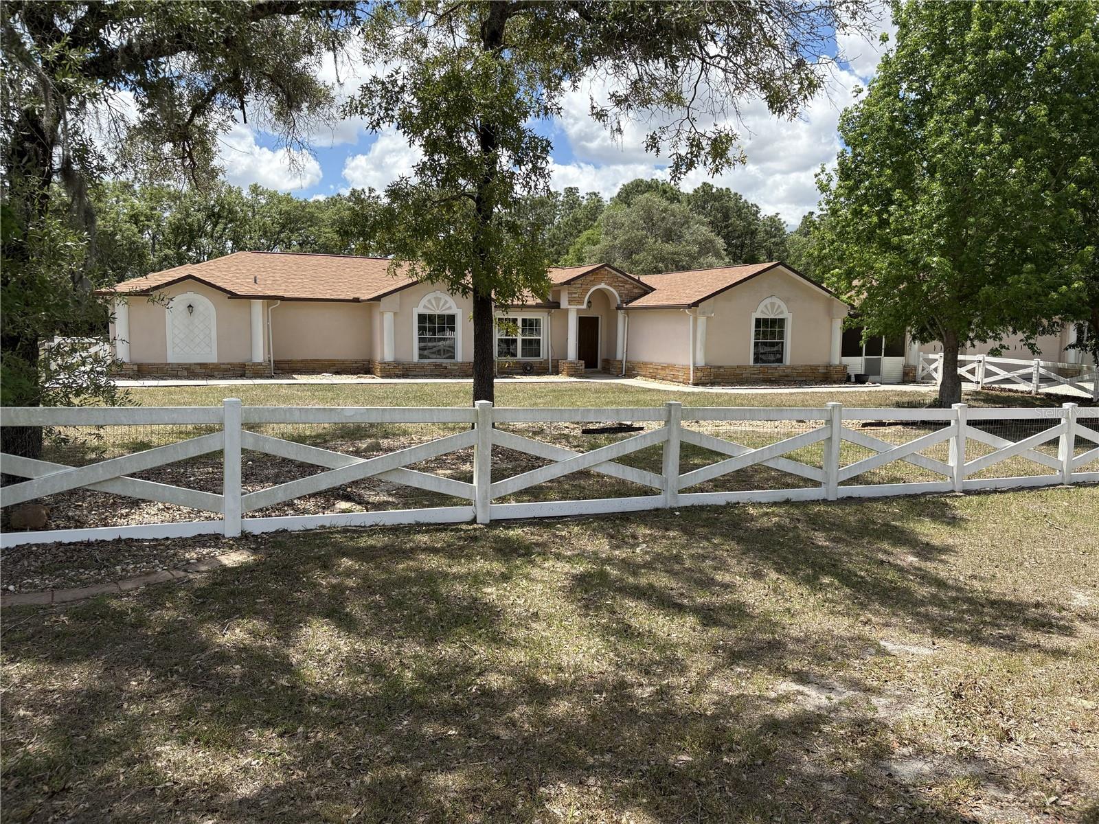 Welcome to this spacious 2,564 sq. ft. home located in the highly sought-after Oakwood Acres community, offering the perfect blend of space, comfort and country living. The home features 4 bedrooms, 3 full bathrooms, a large bonus/flex room, an attached 3-car garage, and a 576 sq. ft. detached garage/workshop-perfect for storage, hobbies, vintage cars, motorcycles or boat, with a carport to boot! Inside, you'll find an updated kitchen, complete with appliances, granite countertop, and a large island that opens to the family room, making it perfect for entertaining or everyday living. This cozy living area includes a wood-burning fireplace, adding warmth and charm. The ensuite bathroom has a spacious ADA accessible bathroom with dual vanity sinks and a large, open shower (no bathtub), a separate HVAC, thermostat, and water heater, as well as a private entry door that opens to the large, spacious 2.5 acre cleared, flat yard. Outside you will find a large, partly covered, partly screened in patio with plenty of space for entertaining. This home also comes with a fully wired-in propane Generac Generator, providing you comfort and security during hurricane season. Only minutes to the Suncoast Expressway with a straight shot to Tampa/Tampa Airport to the south and restaurants, medical facilities, and shopping to the north.
