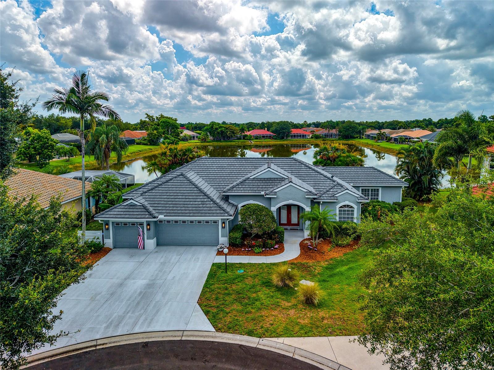 Welcome to this beautifully updated 3-bedroom, 2-bath residence with a spacious 3-car garage featuring epoxy floors, perfectly positioned on a lakefront homesite. Designed for both everyday comfort and exceptional entertaining, this move-in-ready home showcases extensive upgrades throughout. Step inside to discover elegant crown molding, tray ceilings, designer chandeliers, and matching plank-style tile flooring flowing seamlessly throughout the home. The large kitchen is a chef’s dream, featuring premium Bosch appliances, a Sub-Zero refrigerator, a convenient wet bar, and finishes that blend style and functionality. The expansive primary suite offers a private retreat with a beautifully renovated en-suite bath, a private den/workout area enclosed by stylish barn doors for added privacy, and spacious his-and-her walk-in closets. Both bathrooms have been updated with modern finishes and fixtures.

 Indoor and outdoor living blend effortlessly as double sliding glass doors open to the expansive lanai and newly resurfaced glass tile pool (2024), creating the ultimate entertaining space. Enjoy tranquil lake views while relaxing poolside or hosting guests in the outdoor kitchen. This backyard oasis truly delivers the Florida lifestyle you've been searching for. Additional recent improvements include a new tile roof (2025), fresh exterior paint, epoxy-coated garage floor, and numerous additional updates throughout the home, providing peace of mind for years to come. Offering the feel and finishes of a luxury home without the burden of luxury HOA fees, this property presents an exceptional value in today's market. 

Centrally located in one of Sarasota's most convenient areas, this home offers easy access to the Legacy Trail, top-rated dining, shopping, recreation, and everyday conveniences, all just minutes away. Just over a mile from highly regarded Ashton Elementary School and Sarasota Middle School, this exceptional property combines luxury, comfort, convenience, and access to some of Sarasota County's top schools.