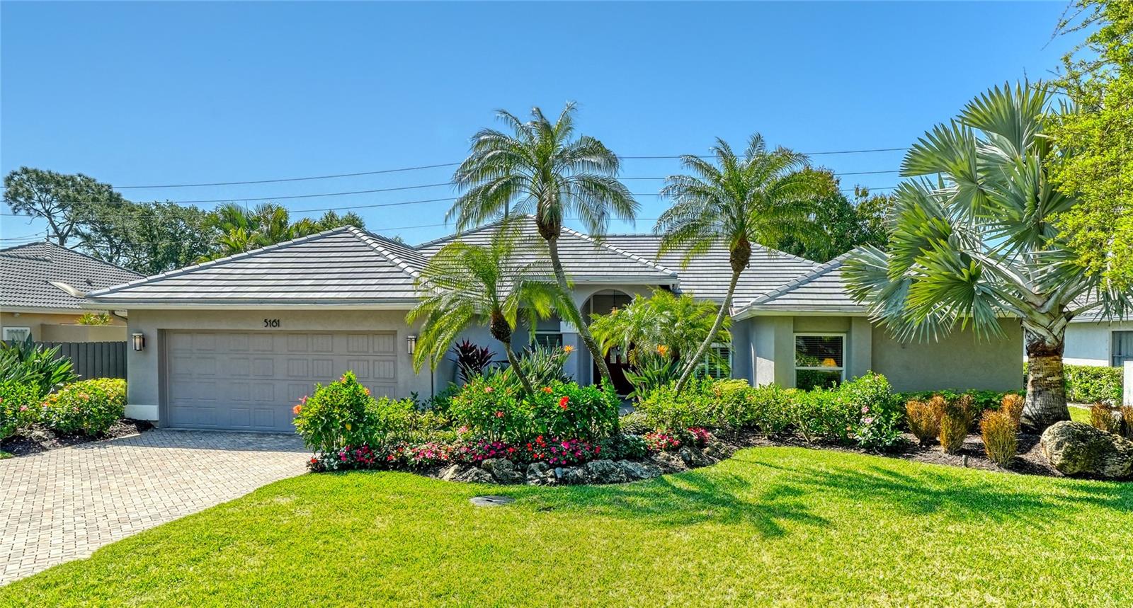 Welcome to this beautifully updated four-bedroom, two-and-a-half-bath residence, ideally situated in The Landings, one of Sarasota's premier gated communities. Set amid lush, mature landscaping behind a 24-hour manned gate, this exceptional home has been thoughtfully enhanced with extensive recent upgrades, including a new tile roof (2025), impact-resistant windows and sliding glass doors, and wide-plank luxury vinyl flooring that beautifully replicates the warmth and character of natural hardwood.

Designed for both comfortable everyday living and effortless entertaining, the light-filled open floor plan showcases soaring vaulted ceilings, expansive living spaces, and a spacious kitchen featuring a center island, breakfast bar, and updated appliances. The kitchen flows seamlessly into the inviting family room, where a stunning white quartz stone wood-burning fireplace serves as an elegant focal point. An adjoining atrium bathes the interior in natural light while creating a seamless connection to the outdoors. A well-appointed inside laundry room features a closet, cabinetry, a large sink and washer and dryer.

The thoughtfully designed split-bedroom floor plan offers four bedrooms, with the versatile fourth bedroom ideally suited as a private home office, complete with a closet. Rich dark wood flooring in both the office and primary suite adds warmth and sophistication, while the spacious owner's retreat features a walk-in closet and a beautifully appointed bath with dual vanities, a walk-in shower, soaking tub, and a peaceful garden atrium.

Outdoor living is equally impressive, offering a screened lanai designed for year-round enjoyment. The heated pool is surrounded by an expansive paver deck and a large gathering area, creating the perfect setting for relaxing or entertaining family and friends. A 500-gallon underground propane tank provides a convenient fuel source for the home's generator. Additional highlights include an outdoor beverage refrigerator and a paver driveway that enhances the home's outstanding curb appeal.

The Landings residents enjoy 72 acres of beautifully maintained grounds with scenic walking and biking trails, along with a picturesque gazebo overlooking the Intracoastal Waterway. Optional membership to the Landings Racquet Club provides access to eight Har-Tru tennis courts, a fitness center, heated pool and spa. Just outside the gate is The Landings Shopping Center with restaurants, Publix and EOS Fitness. Ideally located just minutes from Siesta Key Beach, Phillippi Creek Marina, downtown Sarasota and top-rated schools, this exceptional home offers the perfect blend of luxury, comfort and an unparalleled Sarasota lifestyle.
