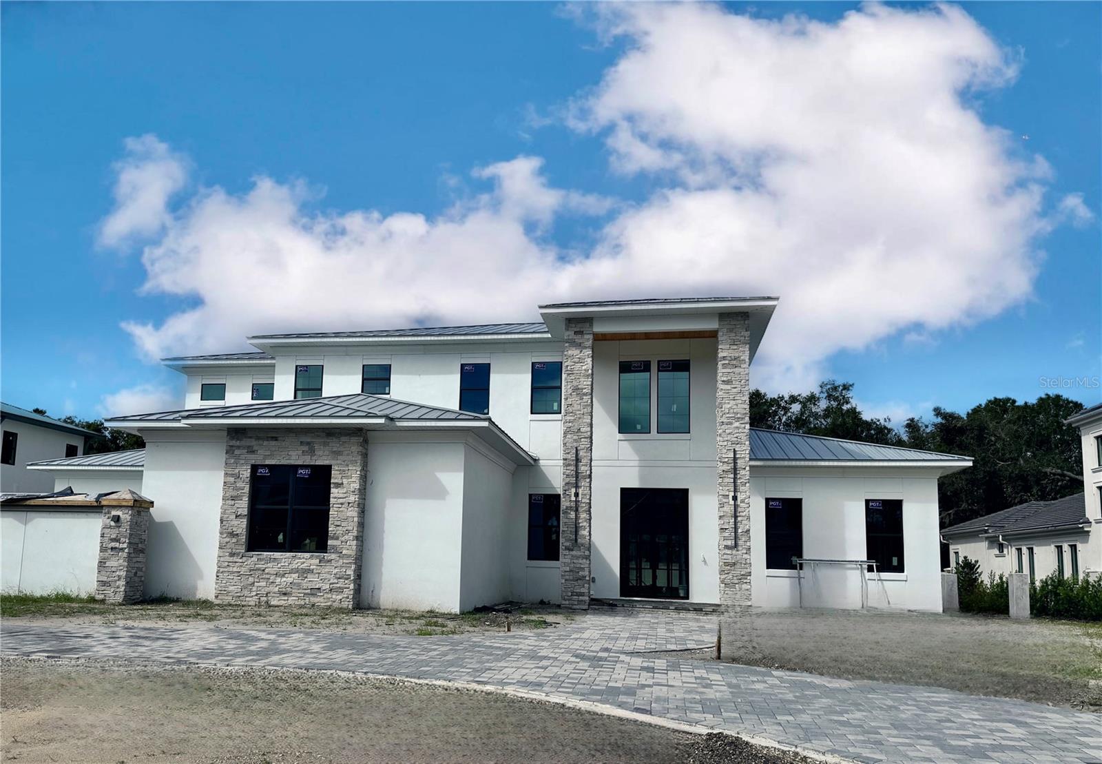 Under Construction. New Construction in Avila! Welcome to this stunning custom-designed home in Avila, Tampa Bay’s premier golf and country club community. Built by BNCH, INC., one of Avila's premier custom home builders, this estate offers an exceptional opportunity for the discerning buyer. Nestled on Orbita de Avila, the final street in Avila to be developed, this residence showcases the finest luxury finishes and amenities.  From the moment you arrive, you will notice the striking 12-foot custom front doors welcoming you into an expansive open floor plan. Featuring 5,334 sq. ft. the home features 5 bedrooms, 5 bathrooms, a game room, wine room, home theater, a 4-car garage, and a luxurious swimming pool with spa. Every detail  of this home is built to modern codes and the highest architectural standards and is planning to be completed by the end of 2024. Custom doors, wide plank wood floors, intricate millwork, and designer lighting combine to create a truly spectacular home. The gourmet kitchen, a chef’s dream, is equipped with top-of-the-line Viking stainless steel appliances, a gas range, custom cabinetry, and quartz countertops. The kitchen flows seamlessly into the family room, highlighted by a wood-beamed ceiling, wet bar, and linear fireplace, offering the perfect setting for entertaining. The first floor includes a luxurious primary suite with a custom-designed walk-in closet, his-and-her vanities, a separate water closet, soaking tub, and a spacious glass-enclosed shower. Additionally, an ensuite guest bedroom on the main floor provides ideal accommodations for family or guests. Upstairs, you’ll find three more ensuite bedrooms, a home theater, and a game room complete with a beverage center, ensuring everyone in the family has their own private retreat. A private backyard oasis features an outdoor kitchen, swimming pool and spa, a spacious pool deck and fully fenced backyard with beautiful landscaping.  Additional features include hurricane impact windows and doors, a metal roof, a generator, tankless hot water heaters and carrier air conditioners. This spectacular estate combines elegance, modern amenities, and the best of Avila living, making it the perfect home for those seeking both luxury and comfort.