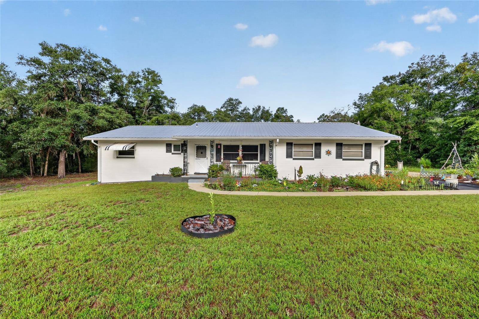 Beautifully updated 2-bedroom, 2.5-bath home on a spacious 0.62-acre lot in desirable Rainbow Lakes Estates! This move-in-ready home offers 1,388 square feet of comfortable living space and has been thoughtfully updated with a new roof (2022), HVAC (2021), energy-efficient windows (2019–2021), screened lanai (2022), and brand-new kitchen appliances (2025). Den can be turned into a 3rd bedroom.  The beautifully landscaped perennial gardens (2024–2026) provide exceptional curb appeal and year-round color. Outside, you'll also find a 20' shipping container, carport, and storage shed, offering plenty of room for hobbies, tools, or extra storage.
Enjoy the relaxed Florida lifestyle with access to Rainbow Lakes Estates' clubhouse, fitness center, parks, playgrounds, tennis courts, fishing pier, and boat ramps on both Lake Bonable and Lake Tiger, perfect for fishing, kayaking, canoeing, and enjoying the outdoors. Conveniently located just minutes from Rainbow Springs State Park and the crystal-clear Rainbow River, and within easy driving distance of the World Equestrian Center, historic downtown Dunnellon, Ocala, Gainesville, Crystal River, and Florida's Gulf Coast, this home offers the perfect combination of modern updates, outdoor recreation, and small-town charm. USDA financing may be available for qualified buyers.