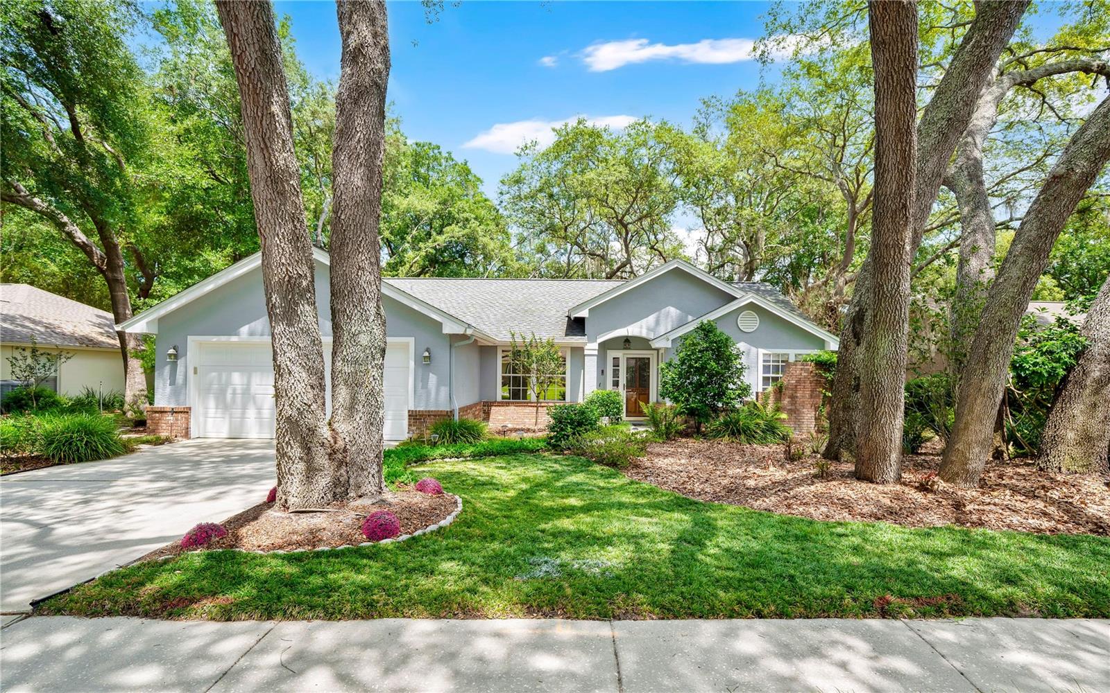 Welcome Home to this very well cared for gem in the Misty Oaks subdivision. Gorgeous landscaping and mature oak trees on a quarter acre lot help give this home massive curb appeal. This home is sprawling and feels larger than it is with a split plan with a dining room, living room and family room. The kitchen has been updated with granite counters, solid wood cabinets and a sleek 2 tone black and stainless appliance package. The primary suite is massive with a walk in closet and sliding door on to the screened lanai, the bathroom has granite with dual vanity, garden tub with tons of natural light (and a privacy wall), and a separate glass shower enclosure. The family room has a wood burning fireplace and overlooks the huge private, low maintenance backyard. This house is needs nothing and is ready to go you the old Lake Mary lifestyle.