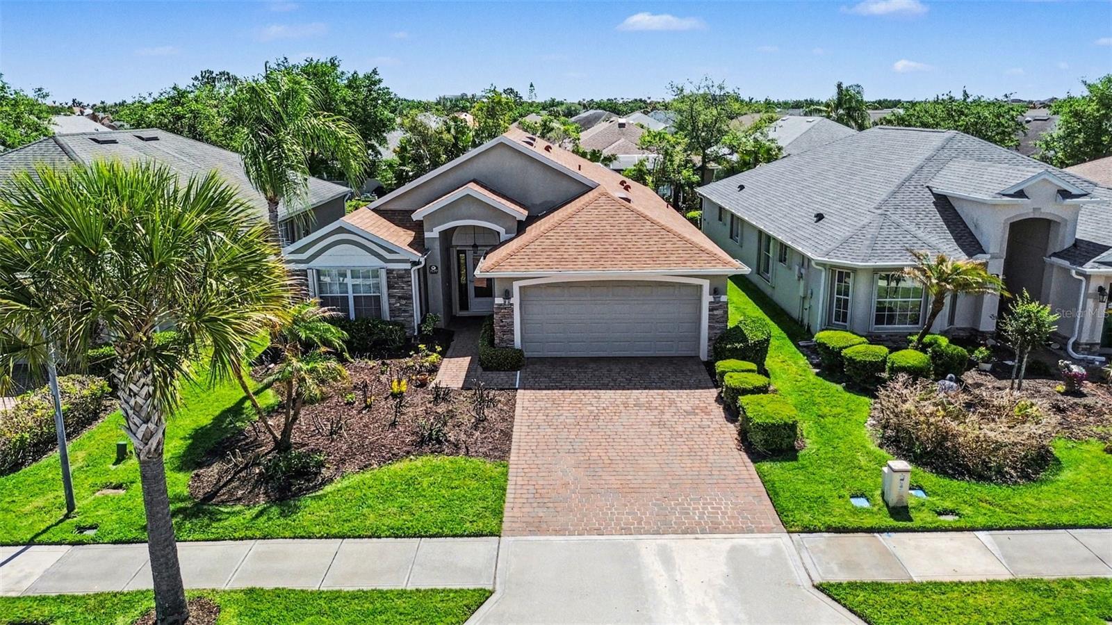 Priced to sell! Beautiful 3 bed, 2 bath pool home in spectacular Heritage Isle gated 55+ community. Tree lined streets, walking paths, ponds, & paver driveway to move-in ready manor home. Open floor plan & vaulted ceilings in light & bright setting. Large primary bedroom, double sinks, roll in shower, custom closet. Split plan, 2 spare bedrooms, tub/shower combo in guest bath. Eat-in kitchen, breakfast bar, ample cabinets, large pantry. Living, dining & family rooms all flow to screen enclosed private pool & spa. Freshly painted interior. Roof 2022. AC 2018. Accordion Hurricane Shutters! Incredible community amenities. Resort style Pool, Tennis, Pickleball, Bocce, Shuffleboard, Horseshoe, and Outdoor Lakefront Pavilion. Private restaurant, Isle Bar & Grill. Work out in the gym, play cards, games, billiards, or join a club! Activities galore! Bike to Viera Wetlands for bird watching. Short drive to Duran Golf Club. Endless shops & restaurants around The Avenues.