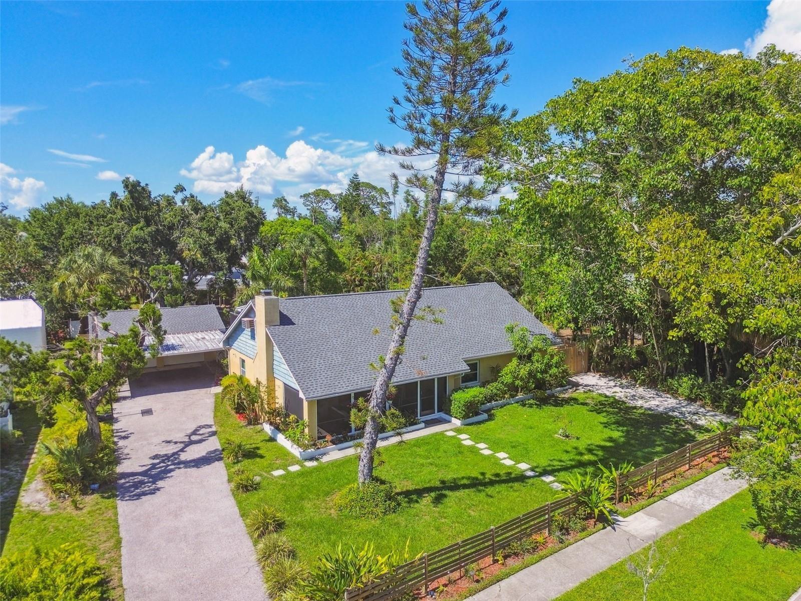 Aggressively priced and ideally located West of the Trail just one block from Sarasota Bay, this spacious 4-bedroom, 4-bath residence offers exceptional value in one of Sarasota's most desirable neighborhoods. Situated on a beautifully maintained 1/3-acre lot, the property features over 2,800 square feet of living space, a sparkling pool, detached two-car garage with attached two-car carport, and no HOA restrictions.

The flexible floor plan includes three bedrooms on the main level, including a private guest suite with its own entrance, kitchenette, bedroom, and bath—ideal for multigenerational living, visiting guests, or as a proven income-producing rental opportunity. A dedicated laundry room is conveniently located off the kitchen.

Upstairs, the loft level offers additional living space with a bedroom, a large bathroom with walk-in shower, and a smaller room perfect for a walk-in closet, office, or storage. A spacious bonus room provides excellent flexibility for a media room, game room, hobby space, or additional gathering area.

The oversized lot offers plenty of room to enjoy Florida's outdoor lifestyle while providing privacy and space rarely found at this price point. Enjoy an unbeatable location just minutes from downtown Sarasota's dining, shopping, arts, and cultural attractions, SRQ Airport, UTC Mall, St. Armands Circle, and the renowned beaches of Siesta Key, Lido Key, and Longboat Key. Nearby attractions also include the iconic The John and Mable Ringling Museum of Art.

The home does require TLC and deferred maintenance, and has been priced accordingly to allow the next owner to make improvements and add personal touches while building immediate equity. Recent permitted improvements include impact windows (2022), new roof shingles on the main house (2021), reroofed garage and shed (2021), 3.5-ton 16 SEER HVAC system (2020), and interior renovations including closet modifications, enlarged living room entry, and bathroom vanity updates.

Importantly, the property has never experienced flooding and sustained no hurricane damage in 2024. Opportunities combining this size, location, income potential, oversized lot, and value are increasingly rare. If you have vision and are looking for a home with great bones in a premier Sarasota location, this property is ready for its next chapter.

All measurements are approximate and should be verified by the buyer.