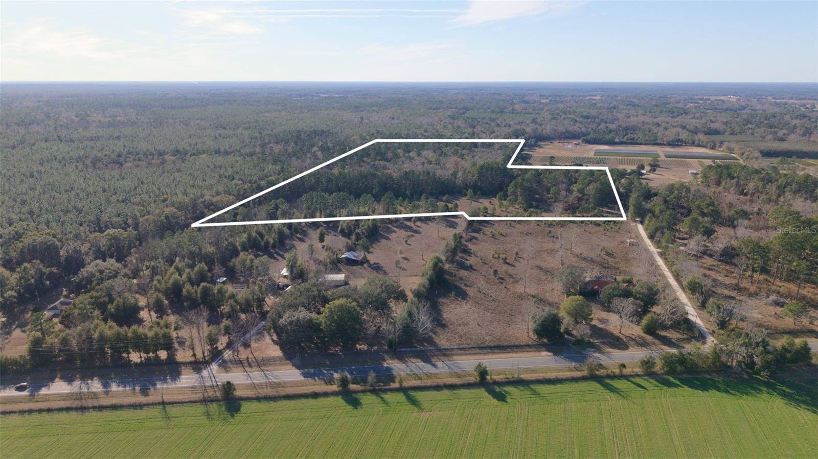 Welcome to your North Florida retreat at 14403 NW 258th Place in Alachua.
Set on 31.77 sprawling acres, this property offers the perfect blend of privacy, natural beauty, and livable comfort. A mix of open pasture and mature woods creates a scenic landscape ideal for those seeking space to roam, farm, hunt, or simply enjoy the peace and quiet of country living.

At the heart of the property sits a 2-bedroom, 2-bath home, surrounded by rolling acreage and towering trees. The home provides a comfortable base while offering endless potential—whether you envision a full-time residence, weekend getaway, or future expansion. From the aerial views, the property’s impressive size and layout truly shine, with clearly defined boundaries and long, picturesque sightlines across neighboring farmland and forest.

With ample road frontage, wide open skies, and abundant wildlife, this land is perfectly suited for horses, cattle, recreation, or a private homestead. Despite its secluded feel, the property is conveniently located just a short drive to Alachua, High Springs, and Gainesville, giving you the best of rural living with nearby amenities.

Highlights:

31.77 acres of usable land with wooded and open areas

2 bedroom, 2 bathroom home

Peaceful, private setting with beautiful aerial views

Ideal for farming, recreation, or future development

Convenient access to Alachua and surrounding communities

This is a rare opportunity to own a large acreage property with a home already in place—come experience the space, serenity, and potential this North Florida gem has.