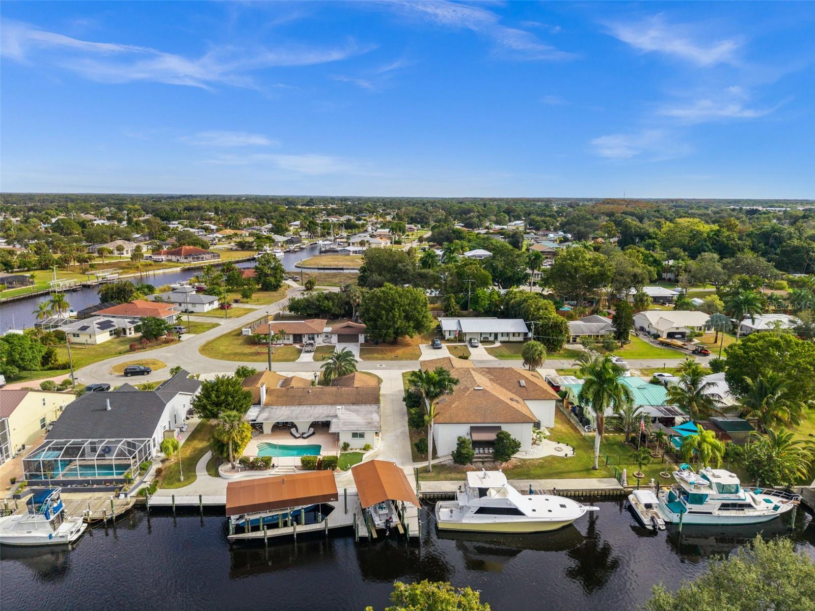 Rare opportunities like this do not come along often. Set on a generous .54-acre waterfront lot with 180 feet of canal frontage, this property offers an exceptional boating lifestyle in one of Fort Myers’ most established and sought-after waterfront communities.
Situated on a wide, deep canal just off the Caloosahatchee River, the home provides easy boating access to Downtown Fort Myers, the Gulf, Sanibel, and Captiva. The canal is freshwater with direct access to saltwater beyond, making it ideal for boaters who appreciate convenience and reduced maintenance when returning home.
The dock spans the entire width of the property, creating a setup that feels more like a private marina than a typical residential dock. With two boat lifts, approximately 20,000 lb and 8,000 lb capacities, and ample dock space, there is room to comfortably accommodate multiple boats and fully enjoy life on the water.
The backyard is designed for true Florida living. A pool and outdoor living areas sit just steps from the dock, making it easy to spend the day on the water and unwind poolside in the afternoon. The home’s western exposure delivers beautiful sunset views, while the quiet canal setting offers a peaceful atmosphere. Waterfront dining is just a short boat ride away, and Downtown Fort Myers is a short drive.
One of the most distinctive features of the property is the Waterfront Marine and Recreational Storage Building, offering 4,000 square feet of enclosed space designed to accommodate boats, RVs, classic cars, and recreational vehicles. With generous driveway access and an RV hookup, this structure provides exceptional on-site storage and functionality that is rarely found in waterfront properties, allowing owners to keep everything protected, organized, and ready for use.
This is a truly unique waterfront offering that combines land, boating access, extensive dockage, substantial enclosed storage, and lifestyle in a way that is increasingly difficult to find. An ideal fit for avid boaters, seasonal residents, or anyone seeking a distinctive Southwest Florida waterfront retreat.