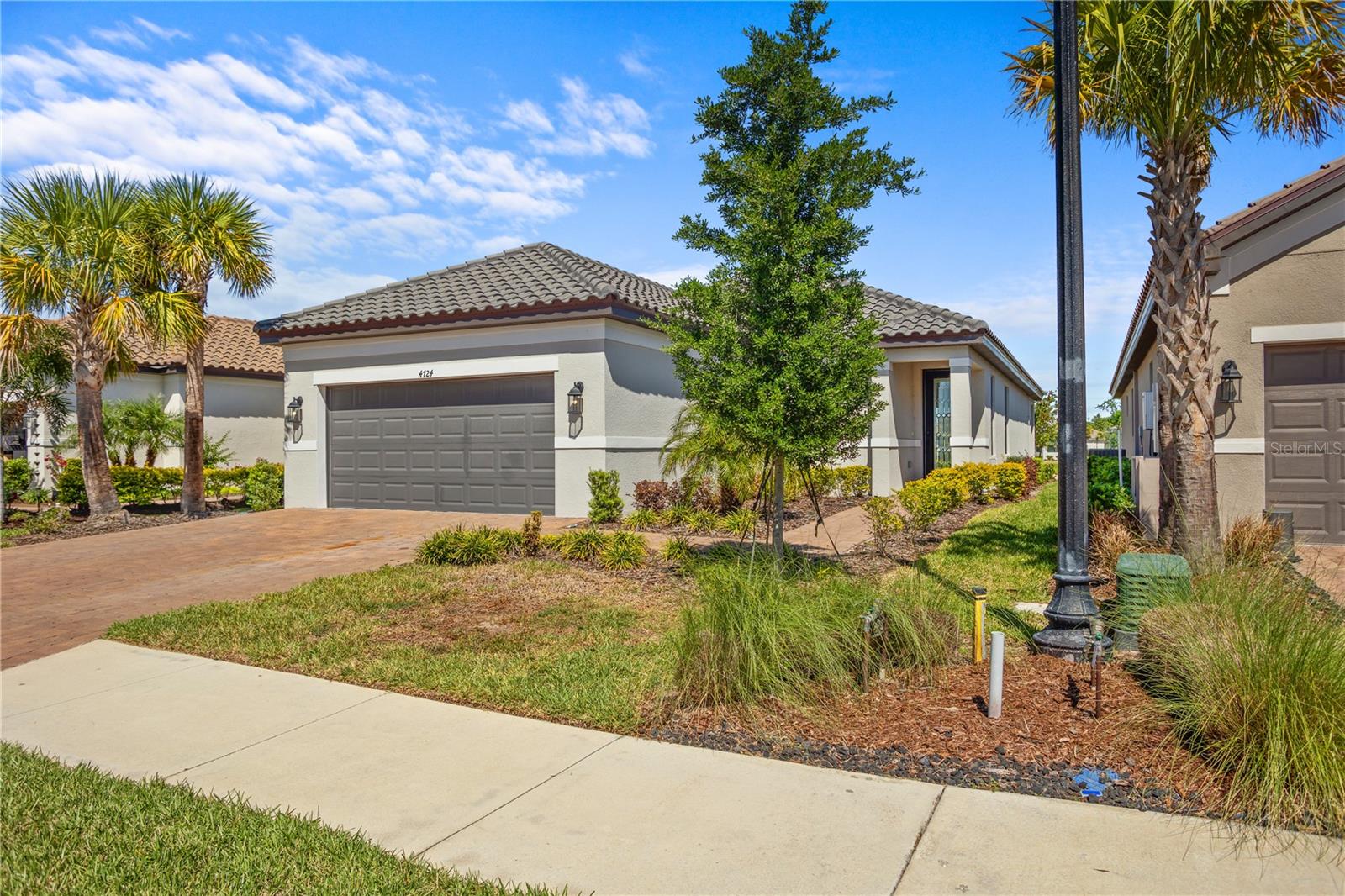 Welcome to an exceptional luxury retreat where elegant design, thoughtful upgrades, and breathtaking water views come together to create the ultimate Florida lifestyle. Located in an amenity-rich, resort-style community, this beautifully appointed residence offers upscale living with effortless indoor-outdoor entertaining.

A stunning upgraded entry welcomes you into a light-filled open floor plan designed for both everyday comfort and memorable gatherings. The spacious great room flows seamlessly into the chef's kitchen, featuring solid wood cabinetry, quartz countertops, an expansive center island, stainless steel appliances, and a custom pantry with built-in organization. Tray ceilings add architectural elegance throughout the main living areas and primary suite.

The outdoor living space is truly extraordinary.  Just beyond, your private backyard oasis awaits with  overlooking sweeping panoramic pond views that wrap around the rear and side of the property, creating a peaceful and private waterfront setting.

Residents enjoy an impressive collection of resort-style amenities, including two community pools with spas, pickleball, tennis and bocce courts, a fitness center, clubhouse, billiards room, two dog parks, and an active social calendar. HOA fees include lawn maintenance, cable, internet, and full access to all community amenities, allowing for truly maintenance-free living.

Ideally located near premier shopping, dining, entertainment, and with convenient access to both Tampa and Sarasota International Airports, this exceptional home offers the perfect combination of luxury, privacy, convenience, and resort-style living. This is Florida living at its finest.
