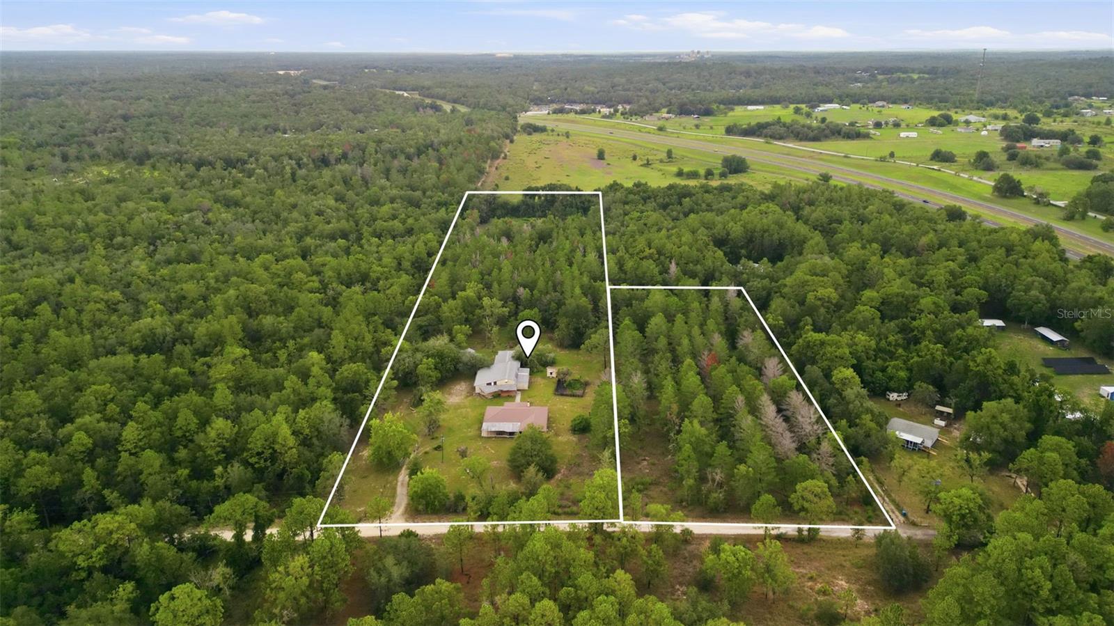Virtually Staged. Country living at its finest!  This contemporary 3/2/2 home boasts a massive 12 acre lot for peaceful and serene life on a secluded and wooded lot.  This home has been recently updated with fresh paint and flooring throughout its split floor plan with a spacious open kitchen overlooking the family room and fireplace.  The master bedroom comes complete with his and hers walk-in closets as well as a large master bedroom.  The home features a quiet screened patio overlooking this expansive property perfect for entertaining or a quiet morning coffee, while the sprawling land around the home offers plenty of opportunity for expansion.  The property has nearly 4,000sf of barn space complete with two garage bays, loft storage space, electricity/water, workshop area, and its own private bathroom ready for any project or job your heart desires.   The entire property is fenced and cross-fenced, and comes equipped an oversized storage building, a large garden plot, as well as a potting shed perfect for the gardener at heart.  The home also features a low maintenance metal roof, additional covered carport parking in addition to the 2 car garage, screened front porch, a private gate, water softener system, and twin water wells.  This property is the epitome of quiet country living while only being minutes from the shopping and restaurants of Cortez Blvd., a short drive from scenic downtown Brooksville, and with quick access to Downtown Tampa via the 589.  Opportunities such as this do not come along often, schedule your showing today, this property will not last long.