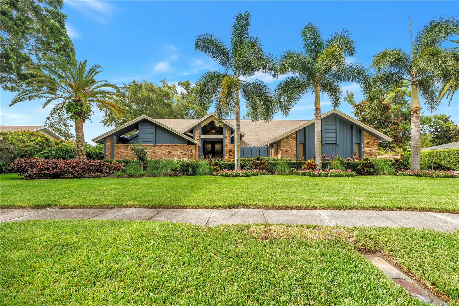 Welcome to this beautifully updated custom residence in the highly desirable Northwood Estates community. Situated on a professionally landscaped 0.40-acre lot, this exceptional single-story home offers over 4,600 square feet of thoughtfully designed living space with 5 bedrooms, 5 bathrooms, and an incredible blend of luxury, comfort, and functionality. From the moment you arrive, you’ll appreciate the impressive curb appeal, mature landscaping, and extensive updates throughout. The spacious floor plan is ideal for both everyday living and entertaining, featuring multiple living and dining areas, a private home theater, split floor-plan, soaring ceilings, abundant natural light, and quality finishes throughout. The spacious kitchen opens to the main living spaces and is complemented by generously sized bedrooms, including a luxurious primary suite with dual vanities as well as a separate walk in shower and spa-inspired tub. Recent improvements include fresh exterior paint, updated flooring, beautifully remodeled bathrooms, brand new AC units, and numerous designer touches that make this home truly move-in ready. One of the home’s most impressive features is the dedicated private theater room, complete with tiered theater seating, projector and screen—creating the ultimate movie-night experience. Step outside to enjoy the oversized backyard with plenty of room to entertain, play, or design your dream outdoor oasis. The nearly half-acre lot provides exceptional privacy and flexibility while remaining conveniently located near top-rated schools, shopping, dining, golf courses, airports, and the award-winning Gulf Beaches. This is a rare opportunity to own a meticulously maintained, luxury home in one of Clearwater’s most established and desirable neighborhoods. Schedule your showing today!