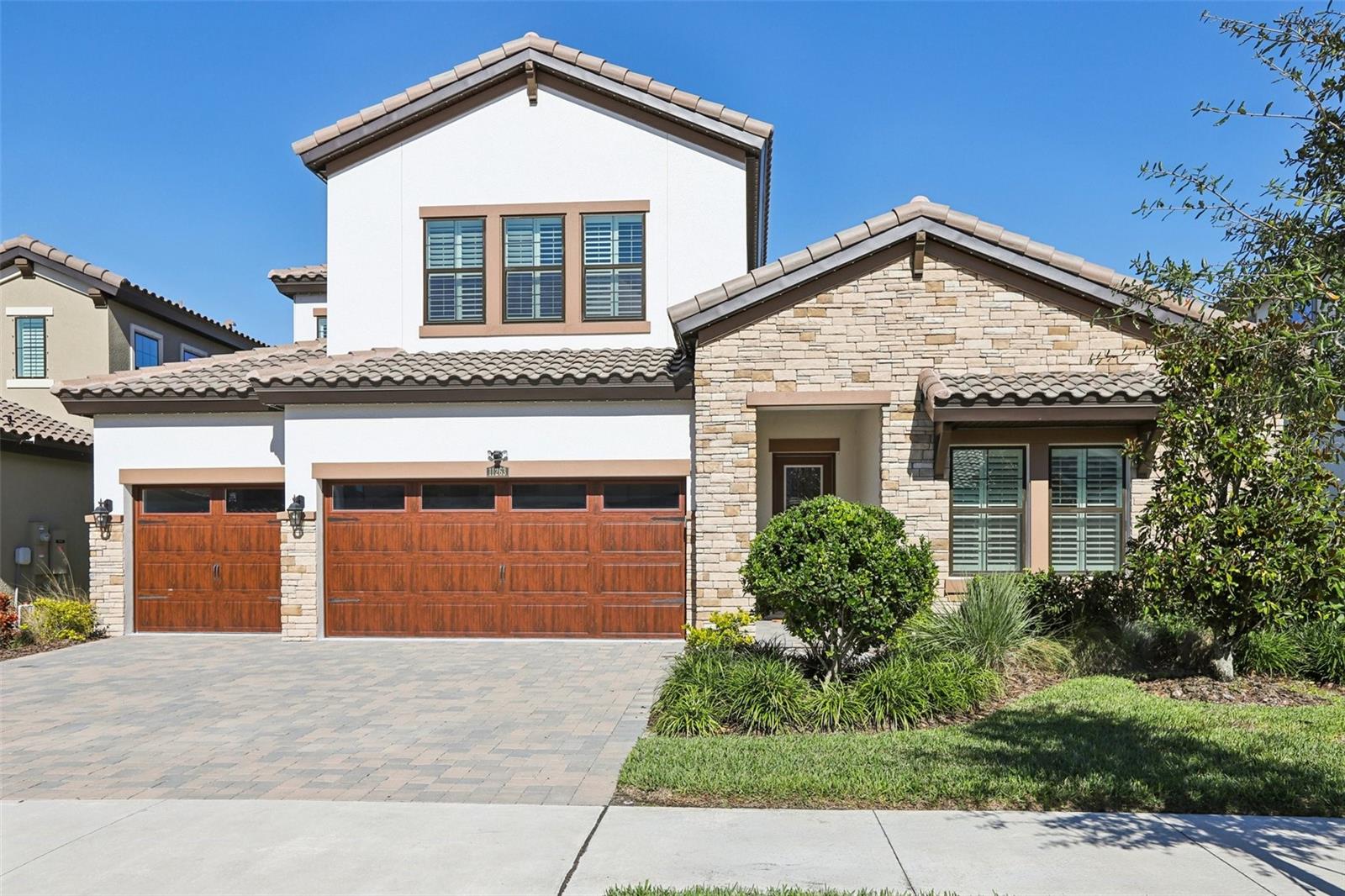 **4 OF THE 5 BEDROOMS, INCLUDING PRIMARY BEDROOM AND OFFICE ARE ON THE FIRST FLOOR LEAVING THE BONUS, 5TH BEDROOM AND 1 FULL BATHROOM ON THE SECOND FLOOR** OVER $130,000 IN STRUCTURAL UPGRADES & OVER $43,000 IN CUSTOM UPGRADES INCLUDED! ASK US FOR THE UPGRADE FLYER FOR DETAILS!**Located within an exclusive gated enclave of the highly sought-after 15-acre lagoon community of Mirada, this stunning Islamorada II offers a rare blend of privacy, sophistication, and resort-style living in fast-growing Pasco County. 
From the moment you step inside, you’re welcomed by wide-plank vinyl luxury flooring, soaring ceilings, and EXPOSED WOOD BEAMS in the grand room that add warmth and architectural character. The open-concept design flows effortlessly into an extended, screened lanai, highlighted by oversized sliding glass doors that create a seamless indoor-outdoor living experience—ideal for both entertaining and everyday enjoyment.
The chef’s kitchen serves as the heart of the home, featuring crisp white cabinetry, quartz countertops, a spacious extended island, and abundant prep and storage space, all overlooking the main living areas for effortless connection.
This thoughtfully designed residence offers 5 bedrooms, 4 full bathrooms, a private office, and an expansive upstairs bonus room, providing flexibility for multigenerational living, work-from-home needs, or recreation.

Upgrades include: exposed wood beams, backsplash to ceiling at hood, wall tile to ceiling level 5, level 5 entry door, full light frosted glass pantry door, LG fridge, Custom window shutters, Closet by Design custom shelving in all closets, designer Pottery Barn light fixtures, Gemstone custom exterior holiday lighting, custom power shades for the sliding glass doors, and screened lanai. 
Residents of Mirada enjoy access to the largest man-made lagoon in the country, offering a one-of-a-kind beach environment with swimming, kayaking, paddleboarding, and relaxation just steps from home. The community also features multi-modal trails, playgrounds, dog parks, a nearby Mirada Publix, and convenient access to Kirkland Ranch Academy of Innovation. HOA benefits include an exceptional entertainment package with Disney+, Hulu, AMC+, Peacock, Paramount+, Max, FOX One, ViX Premium, ESPN Unlimited, and the Tennis Channel, along with ultra-fast fiber-optic internet. Residents also enjoy unlimited access to the Mirada Lagoon, exclusive food and beverage discounts, 25 complimentary guest passes annually, and up to six additional guest tickets per day at just $5 each once passes are used.
This exceptional home delivers luxury, comfort, and functionality in a vibrant master-planned community—an opportunity not to be missed.