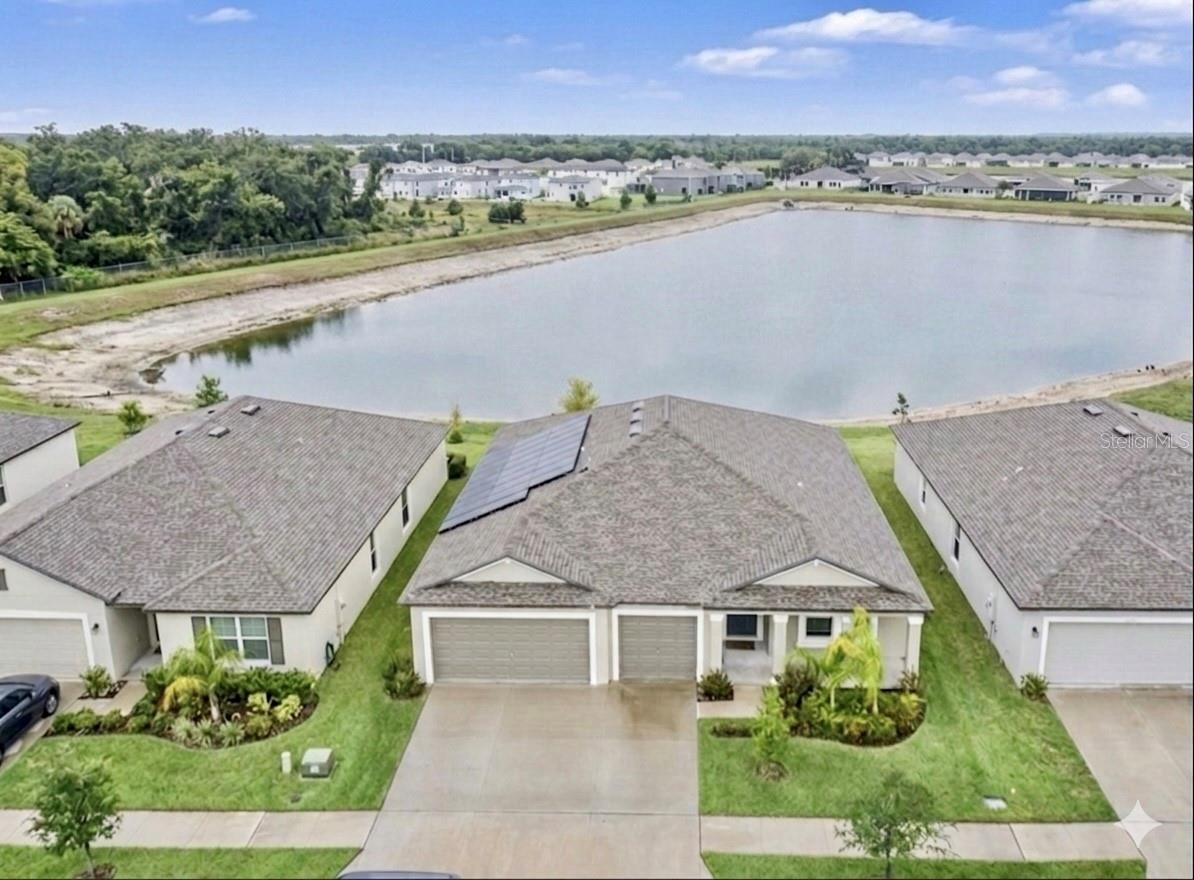 Come experience the Perfect Blend of Luxury, Efficiency, and Tranquillity. This impeccably maintained, move-in-ready home in the highly sought-after Ventana community offers a lifestyle of comfort and incredible cost savings. Designed with sustainability in mind, this home features paid-off solar panels, keeping your electricity bills at a remarkable $20–$30 monthly—a rare and massive financial advantage for any homeowner that values savings. The home is also equipped with a water softener so you can enjoy premium water quality.The heart of the home is a spacious, open-concept kitchen that flows seamlessly into the family room and café—perfect for entertaining. The kitchen is finished with a 36" staggered cabinetry, stunning New Caledonia granite counter-tops, and premium GE® stainless steel appliances. Large-format 18x18 Taupe ceramic tile provides a clean, cohesive look throughout the main living areas. The primary bedroom is positioned for privacy at the rear of the home, featuring a generous walk-in closet and a dual-vanity en-suite bathroom. With three additional bedrooms and a flex room, there is ample space for family, guests, and a dedicated home office. Lets step outside to your own private retreat. Whether you are hosting a BBQ or unwinding in the back yard, the expansive 28'x12' custom-screened lanai with concrete slab and gutters, provides the ultimate bug-free, shaded space to enjoy breathtaking and tranquil pond views. You also get a spacious 3-car garage, offering plenty of room for vehicles and extra storage. Located in the heart of Riverview you are moments away from a resort-style community lifestyle. Convenience is at your doorstep with an easy, 2-3 minute commute to both I-75 and US-301, making trips to downtown Tampa or your favorite local dining and shopping spots a breeze. Don’t miss this opportunity to own a home that blends eco-friendly living with modern convenience. Schedule your private showing today!
