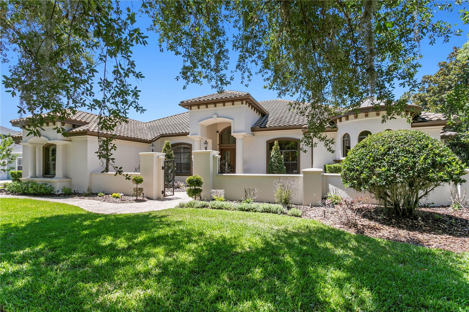 Quite simply… this is the dream! Hands down fabulous with all the wonderful you have been looking for! Built by renowned FHR Premier builder John C. Fowke and tucked behind the gates of one of FishHawk Ranch’s most exclusive villages. The lot has a long driveway for days of outside enjoyment on your private cul-de-sac. Living will be so easy in this home, and the exceptional schools will be just a minute away! Can’t imagine that there is a better village, better street, better cul-de-sac, and I know this is the best house! This is a truly extraordinary custom estate showcasing exceptional craftsmanship and extensive modern updates, including a true 6-bedroom layout. Positioned on a sprawling pie-shaped homesite, the home captivates with its striking elevation, tile roof, grand columns, turret accents, side-entry garage, and private gated courtyard entry. Fresh exterior paint (2024), redesigned landscaping, and elegant landscape lighting (2025) complete the impressive exterior. Rich travertine flooring, extensive custom millwork, crown molding, oversized baseboards, soaring ceilings, and fresh interior paint create an elegant interior. Updated flooring in the main living areas (2024) and hardwood flooring in the primary suite (2022) further enhance the home’s desirability. The executive office features floor-to-ceiling custom built-ins, while the formal living room showcases a dramatic coffered ceiling, stone fireplace, elegant architectural details, and sweeping views of the lanai and pool. A temperature-controlled wine cellar designed to accommodate hundreds of bottles is a rare luxury feature. The 2023 renovated kitchen serves as the centerpiece of the home with updated cabinetry, designer backsplash, luxury countertops, custom wood hood vent, Sub-Zero refrigerator, and premium Miele appliances including a built-in coffee maker (2025), microwave (2024), and dishwasher (2025). An oversized seamless mitered window overlooks the resort-style lanai and pool. The adjoining family room features two sets of pocket sliders, creating seamless indoor-outdoor living. Privately situated on its own wing, the owner’s retreat includes a sitting area with lanai access, dual custom walk-in closets, and a spa-inspired bath with dual vanities, jetted soaking tub, and oversized walk-in shower with triple shower heads. Updated designer lighting adds a modern finishing touch. The thoughtfully designed four-way split floorplan provides privacy for family and guests alike, while the upstairs bonus room, complete with a wet bar, creates the perfect entertaining space. Outside, the oversized screened and pavered lanai features a sparkling pool and heated spa complemented by dramatic rock features, rich wood ceilings, stacked stone accents, an outdoor kitchen, and a stunning gas fireplace. Additional updates include custom window treatments and framing (2025), updated ceiling fans (2025), shiplap feature walls and painted cabinetry (2022), designer lighting updates in the entry, dining room, and primary suite, MyQ smart garage technology, and a permitted 220 electric vehicle hookup (2024). Located in FishHawk Ranch and zoned for top-rated schools, including Bevis Elementary, Randall Middle, and Newsome High School, residents enjoy resort-style amenities, parks, trails, and convenient access to Downtown Tampa, beaches, and Orlando attractions. A rare opportunity to own one of FishHawk Ranch’s most exceptional custom homes.