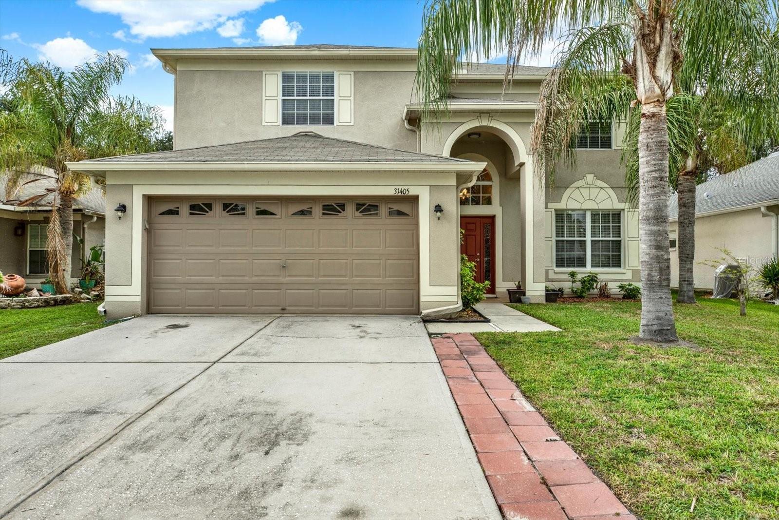 Welcome to the highly sought-after Bridgewater community in Wesley Chapel, where space, style, and convenience come together. This impressive two-story home offers 6 bedrooms, 3 full bathrooms, and over 2,900 square feet of thoughtfully designed living space—perfect for growing families, multi-generational living, or those who simply love to entertain.

Step inside to discover rich wood-look laminate flooring that flows throughout the entire first floor, creating a warm and inviting atmosphere. The formal living and dining room combination provides the perfect setting for gatherings while offering seamless access to the heart of the home—the spacious kitchen. Designed with both function and style in mind, the kitchen features stainless steel appliances, stone countertops, a large center island with bar seating, and abundant cabinet space.

The kitchen opens effortlessly to the expansive family room, highlighted by a decorative brick accent wall and oversized sliding glass doors that fill the space with natural light and lead to the screened lanai—an ideal spot for relaxing or entertaining while overlooking the fenced backyard.

A generously sized first-floor bedroom and full bathroom provide the perfect setup for guests, extended family, or a private home office. Upstairs, the spacious primary suite serves as a peaceful retreat with a large walk-in closet and an en-suite bathroom featuring dual vanities, a soaking tub, and a separate walk-in shower. Four additional bedrooms, another full bathroom, and a conveniently located laundry room complete the second level.

Additional highlights include a large two-car garage and a fully fenced backyard, offering plenty of space for outdoor activities and pets.

Bridgewater residents enjoy wonderful community amenities including a park, playground, and dog park, all while being just minutes from Tampa Premium Outlets, The Shops at Wiregrass, top-rated schools, restaurants, entertainment, and easy access to I-75 for a convenient commute. This exceptional home combines generous living space with an unbeatable Wesley Chapel location—don't miss your opportunity to make it yours!