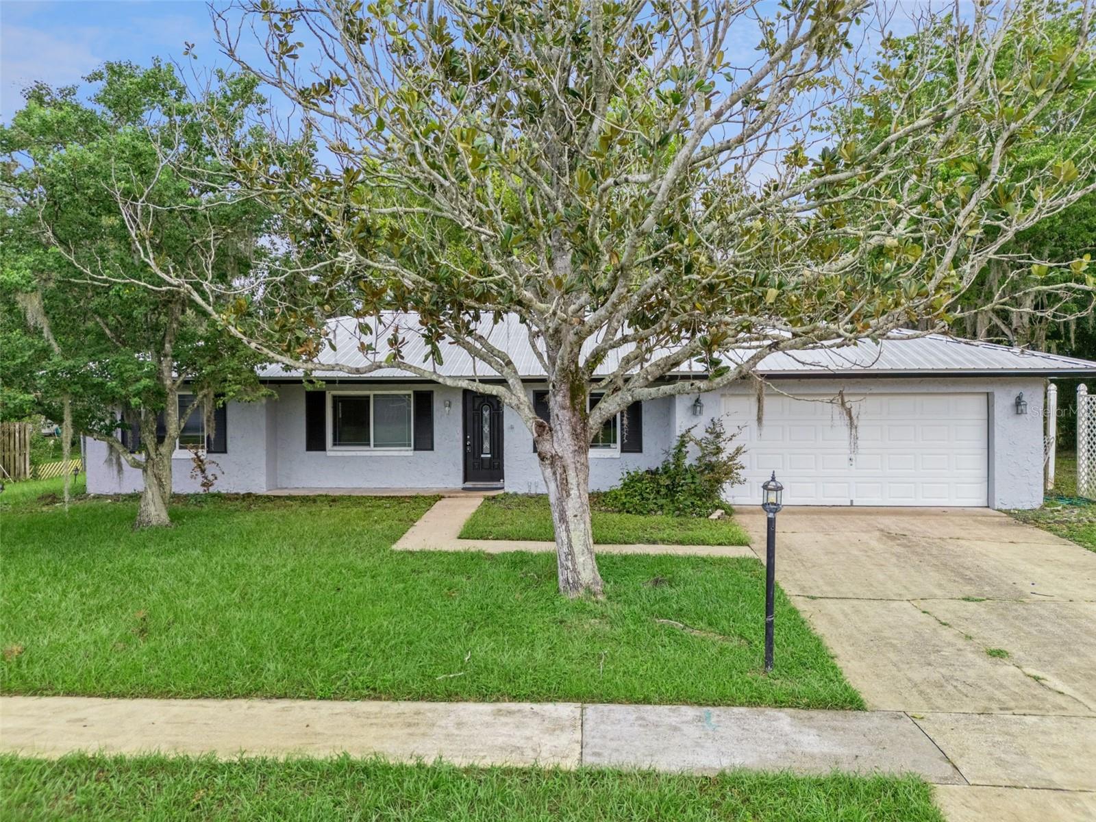 **This house comes with a REDUCED RATE through the seller's preferred lender. This is a lender-paid rate buydown that reduces the buyer's interest rate and monthly payment.**

Welcome to 2142 Kendall Court, a beautifully maintained 3 bedroom, 2 bathroom home offering comfortable living space in the heart of Deltona. Thoughtfully designed with a spacious and functional one story layout, this home provides the perfect balance of comfort, flexibility, and everyday convenience.

The open floor plan connects the main living spaces, making it easy to relax, dine, and entertain. The kitchen is equipped with a double oven, providing added convenience for preparing meals, entertaining guests, or holiday cooking. With both a living room and a family room, the home also offers flexibility for everyday lounging, hosting guests, a media space, play area, or work from home setup.

The 3 bedroom layout provides comfortable space for residents, guests, a home office, or hobbies, while two full bathrooms support daily convenience. The floor plan is practical and easy to personalize around a variety of needs.

Outdoor living includes a covered patio overlooking the private yard. The backyard offers room for seating, gardening, pets, play, or future outdoor improvements, giving buyers the opportunity to create their own outdoor retreat.

Located in Deltona, the home is close to shopping, dining, schools, parks, and everyday conveniences. The area also offers access to nearby lakes, outdoor recreation, I-4, Sanford, Orange City, and surrounding Central Florida destinations, making it a practical location for buyers seeking neighborhood comfort with convenient connections.