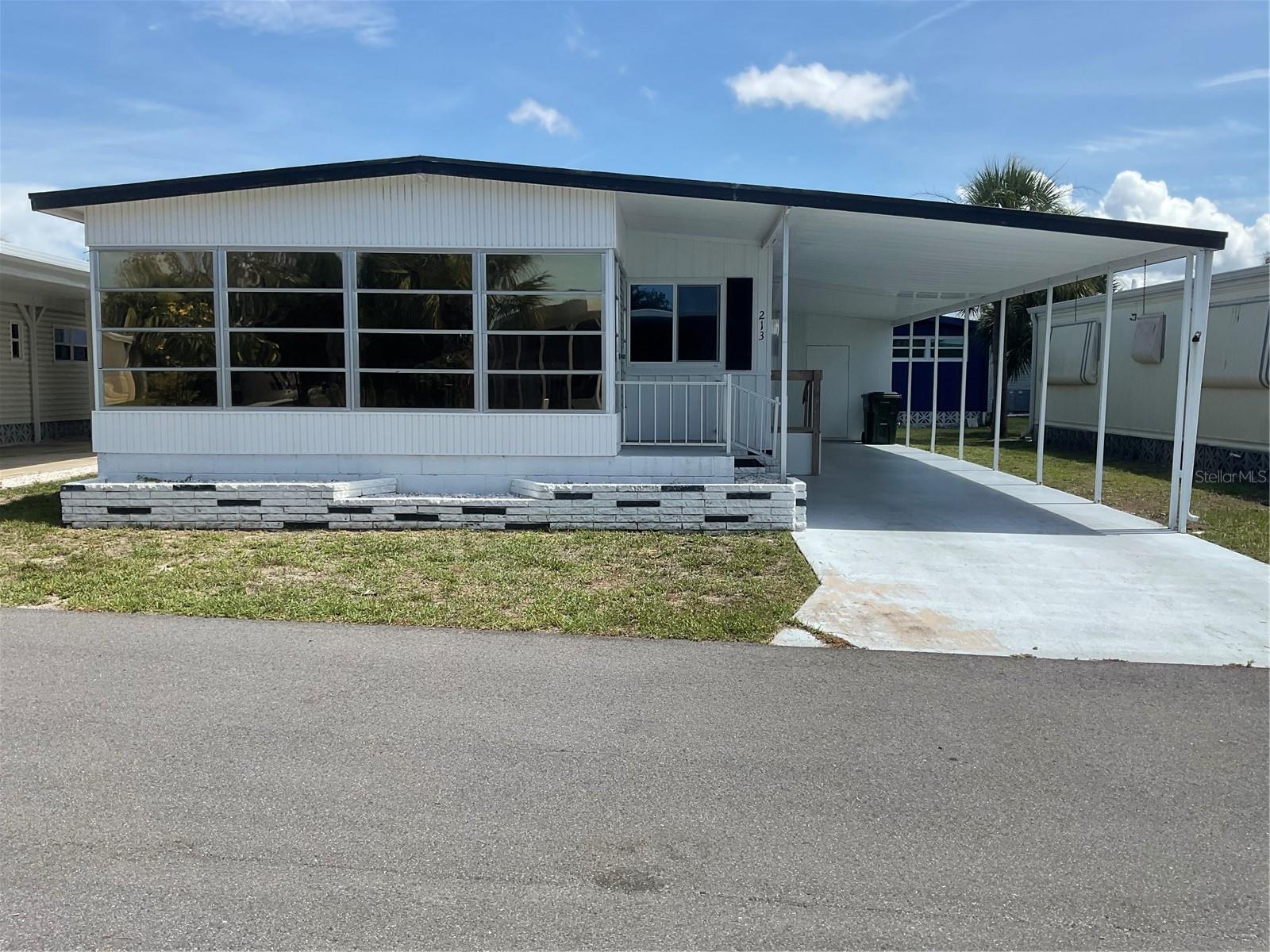 PRICED TO SELL. Cute and Clean fully furnished 2-bedroom, 2-bath home in the desirable 55+ Mobile Home community of Venice Isle. This move-in-ready property features new AC 2024, Membrane roof over 2025 with new windows, newer carpet, laminate flooring, updated bathrooms, newer plumbing, and a new carport. A spacious storage shed provides extra convenience. Enjoy maintenance-free living with access to community amenities and a welcoming neighborhood atmosphere. This charming home is perfect for seasonal or full-time living. The park amenities are numerous and include 2 heated pools, 2 hot tubs, saunas, putt putt golf, a fitness center, tennis courts, bocce ball, corn hole, horseshoes, billiards, ping pong, game room, Tiki Hut, 2 Clubhouses, and free community bus transportation to local shops and outings. There are numerous social events for all community members to take part in. The low HOA fee includes Cable TV and Internet, Lawn Maintenance and all amenities. Located just minutes from downtown Venice and pristine beaches with easy access to shopping, dining, and entertainment options. Whether you are enjoying a sunset stroll on the beach or exploring the charm of downtown Venice, this location offers the best of Florida living.