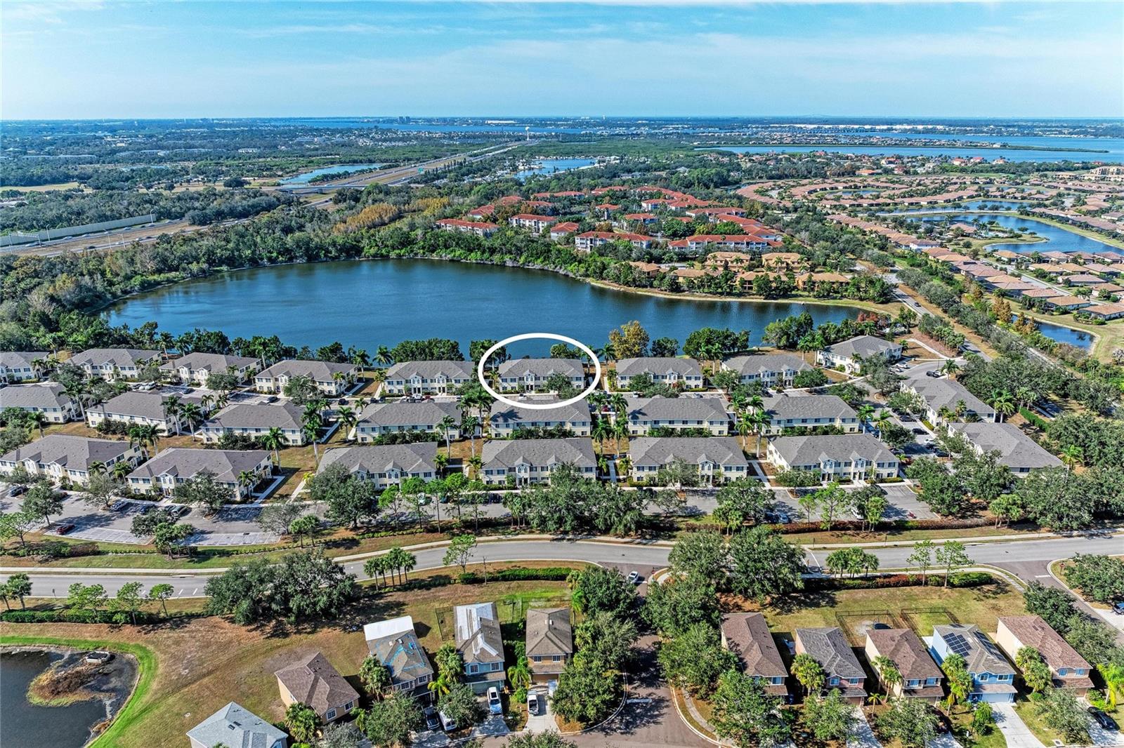 A GREAT PLACE TO START. Perfect for the first time buyer. This Tastefully furnished LAKE FRONT unit is your first step into Home Ownership. No need to spend any cash on furnishings they're waiting for you here. Seasonal residents just bring your toothbrush, swim trunks, a pair of flip flops and plan to spend lots of time at the pool or on the Beach. Savvy investor looking for a ready rental? Sign a Lease at closing and start your income stream. There's lots to love about this amazing Townhome; the kitchen features Granite counters, Maple cabinets, a pantry, newer appliances and a breakfast bar where you will enjoy a morning cup of "Joe" or a quick lunch before heading out to start your day in paradise. The dining room is perfect for holiday gatherings or entertaining friends on the weekend, the GREAT ROOM design fits our active Florida lifestyle and offers access to the Lanai overlooking a REAL LAKE where you can enjoy a glass of wine as the evening settles after another perfect day in paradise. Upstairs two full size bedrooms AND 2 FULL BATHS with a "Flex room" that can be kids play space, an in house office, craft room or a 3rd BEDROOM if and when your family expands. Tile flooring throughout downstairs, wood stairway and Bamboo LVT upstairs in all rooms. FRESHLY PAINTED interior, newer construction standards (built in 2006) keep insurance reasonable, extra storage for bikes, Easy access to I-75 make St Pete or Sarasota a short drive. Amenities include: resort style community pool, park with picnic area, fishing spots and a playground perfect for growing families. IF you're a first time buyer, don't miss an opportunity to make a great first investment in real estate; a seasonal resident, this one won't break the bank, and if you're an investor, bring a lease with you to closing and start collecting rent the next day. What you see is what you get with this one, so CALL TODAY!!!