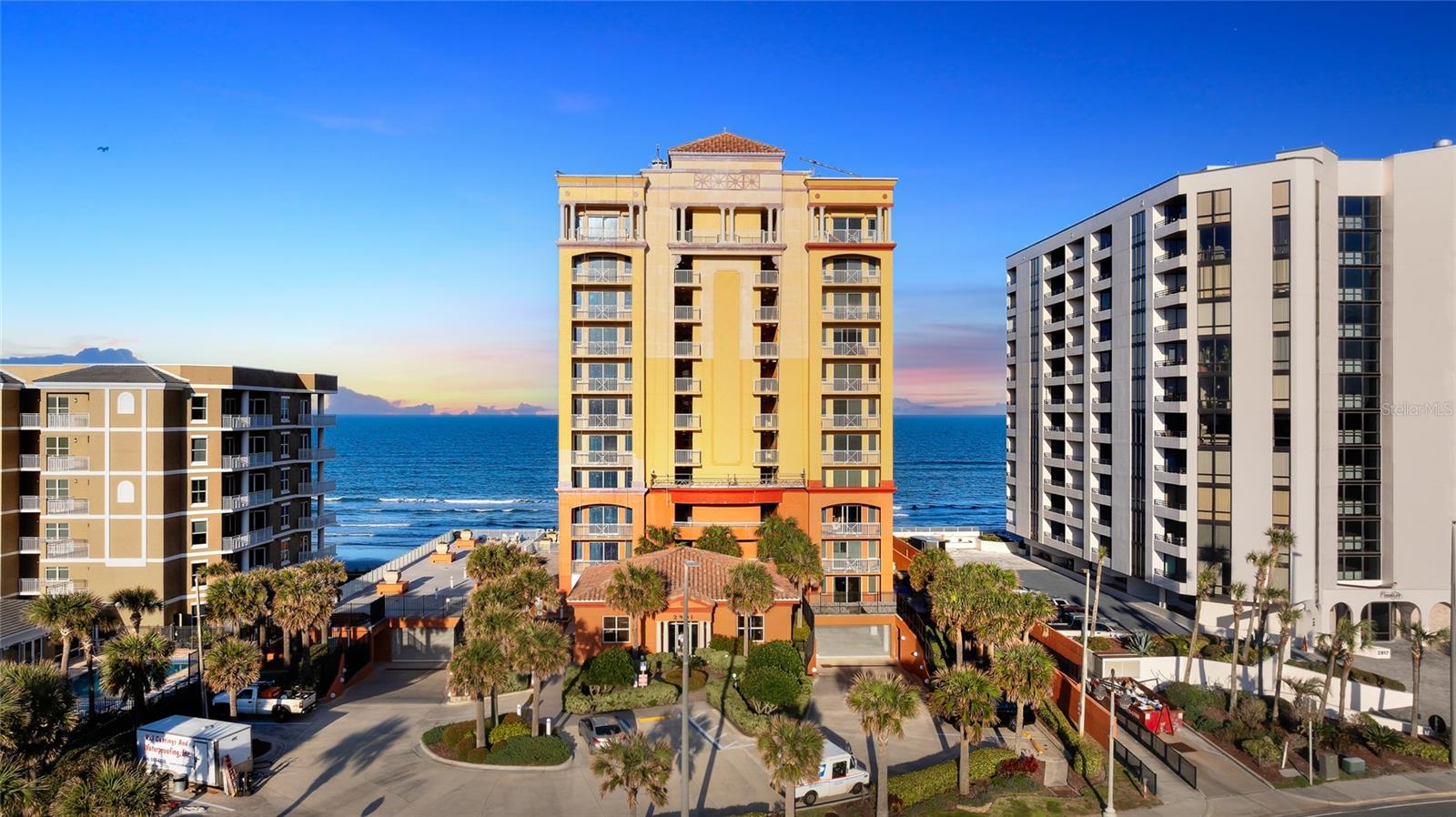 Experience the pinnacle of boutique luxurious oceanfront living at Tuscany Shores with this professionally interior-designed and highly sought-after northeast PENTHOUSE residence, a truly rare offering in Daytona Beach Shores. One of the most valuable and seldom available features of this condominium is the inclusion of THREE premium assigned parking spaces located within the secure, attached underground garage. Spanning 2,822 total square feet, this expansive penthouse runs fully west to east and is intentionally designed to capture breathtaking, completely unobstructed views of the Atlantic Ocean beach, the city skyline, and the Halifax River. An abundance of impact-resistant windows and sliding glass doors fill the home with natural light, while three private terraces provide multiple vantage points to enjoy both sunrise over the ocean and sunset over the river. Tuscany Shores is an intimate luxury building offering only three units per floor, creating true exclusivity across just 33 residences. Penthouse 201 offers a thoughtful and cohesive layout with all living spaces positioned along the north side of the building to maximize panoramic coastal and river views. The primary suite is thoughtfully positioned to capture stunning beach and Halifax River views while offering privacy and comfort. The suite features terrace access, a spacious spa-inspired bathroom with whirlpool tub, walk-in shower, double vanity, and a large walk-in closet with custom built-ins. Throughout the residence you will find wood flooring and tile for carpet-free living, crown molding, 9-foot ceilings, upgraded lighting, and refined custom designer finishes. The kitchen is both functional and elegant, featuring solid wood custom cabinetry, tile flooring, an expansive granite breakfast bar, dual ovens, a high-end Monogram refrigerator installed in 2020, and an oversized walk-in pantry. This penthouse is being offered mostly furnished with high-end furnishings, allowing for a seamless move-in and immediate enjoyment of luxury coastal living. Residents of Tuscany Shores enjoy resort-style amenities including a (coming soon!) private beach access ramp, oceanfront heated pool and jacuzzi, a fully equipped fitness center, and an elegant club room ideal for private gatherings. The community is primarily composed of full-time and second-home owners, offering a peaceful atmosphere with minimal rentals. Pets are allowed with no weight restrictions. Ideally located in the heart of Daytona Beach Shores, residents enjoy close proximity to Publix, banking, pharmacies, golf courses, tennis courts, shopping, dining, boating, and easy access to Orlando attractions. This is a rare opportunity to own a true oceanfront penthouse offering panoramic views, designer custom finishes, three private terraces, and the unmatched convenience of three underground parking spaces. Schedule your private showing today and experience elevated coastal living at its finest.