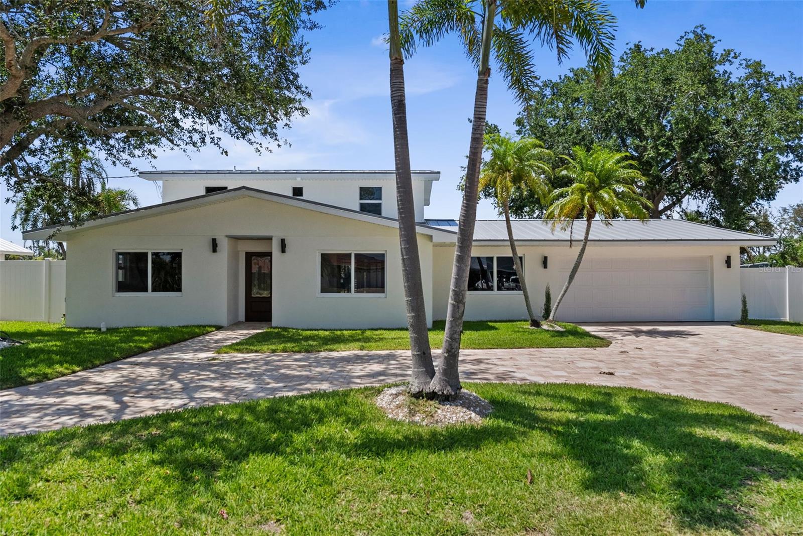 Welcome to your completely renovated waterfront retreat tucked away on a quiet cul-de-sac with a circular driveway and spacious two-car garage, offering exceptional curb appeal and a setting that feels both private and inviting. Step inside to discover a thoughtfully designed layout beginning with a dedicated home office, perfect for remote work or a quiet place to unwind. Continue into the formal dining area, ideally positioned for everything from intimate dinners to larger gatherings. The left wing of the home features two versatile guest bedrooms and a beautifully updated full bathroom, creating the perfect space for family, guests, or additional flex space. To the right, the heart of the home awaits with a chef-inspired kitchen designed to impress, complete with stunning water views that make cooking and entertaining even more enjoyable. Just off the kitchen, you'll find an oversized walk-in pantry along with a spacious laundry room featuring abundant cabinetry and storage. A charming under-stair wine display adds character and serves as a unique decorative touch within the home.
Upstairs, the expansive primary suite serves as a true private retreat featuring a spa-inspired bathroom with a large walk-in shower, generous closet space, and a private balcony where you can enjoy peaceful mornings overlooking the water. Outside, the pool and large backyard create the perfect setting for enjoying Florida living year-round, whether hosting friends and family or simply relaxing while taking in the tranquil views. Located in one of the area's most desirable waterfront communities in Bradenton, this home offers convenient access to beautiful Gulf beaches, shopping, dining, parks, and everything that makes the Florida lifestyle so special. Combining a complete renovation with an exceptional layout, water views, and outstanding outdoor space, this is a rare opportunity to own a truly move-in ready home.