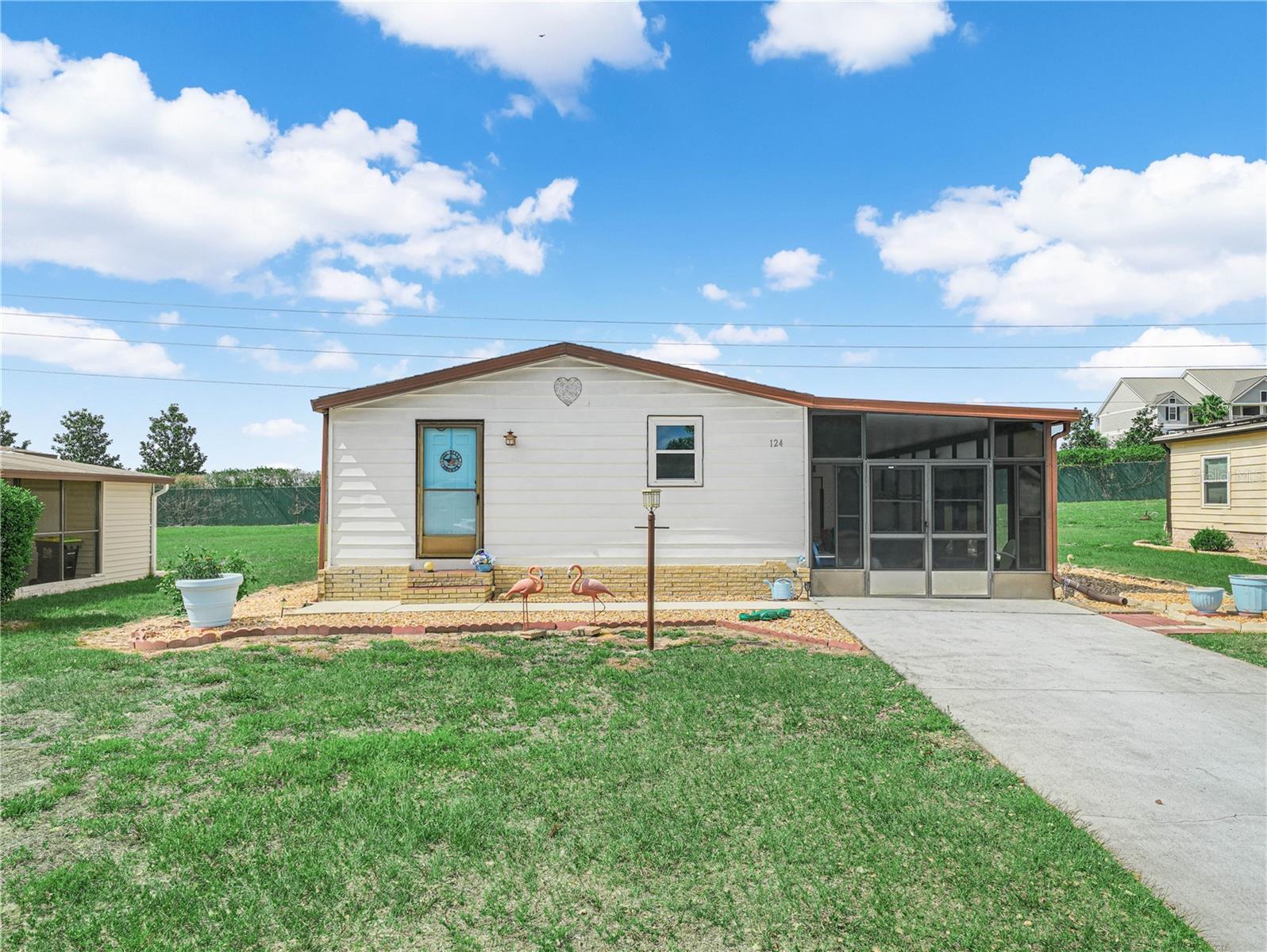 This is a beautifully maintained 2 bedroom 2 bathroom doublewide mobile home in Polo Park West. There is a very large screen room to enjoy the Florida weather with windows that close up tight in case of rain. When you enter the house the kitchen is on your left and the dining area is on the right. There is a built in hutch in the dining area. The furnished living room invites you and your guest to relax. The primary bedroom has its own bath with a walk in shower and walk in closet. The guest bedroom and guest bathroom are adjacent. This is a house that is ready for a new owner whether it is as a year round home or as a winter get away.