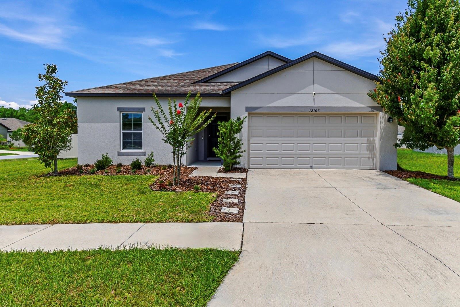 One or more photo(s) has been virtually staged. Welcome to the M/I Homes Sentinel "A" model, a beautifully maintained 4-bedroom home situated on just under 1/4 acre corner homesite in the highly desirable Talavera community of Pasco County. Built in 2019 and featuring a fully fenced backyard, this exceptional property offers both privacy and functionality. The thoughtfully designed split-bedroom floor plan welcomes you through a trussed front porch into a spacious foyer that leads into the heart of the home. The upgraded kitchen is appointed with granite countertops, 42-inch neutral upper cabinets with crown molding, stainless steel appliances, a large eat-in island, and a walk-in pantry, creating the perfect space for everyday living and entertaining. Additional thoughtful upgrades include: hurricane shutters for added protection, built-in cabinetry in the laundry room for extra storage and convenience, and granite vanities in all bathrooms paired with beautifully tiled showers, showcasing quality finishes throughout.
Privately located at the rear of the home, the primary suite features a custom-built closet system and a well-appointed en-suite bathroom complete with a granite vanity and a tiled step-in shower with glass enclosure. Three additional bedrooms provide ample space, each offering generous closet storage. Step outside and enjoy the expansive fully fenced backyard, offering plenty of room for outdoor living, recreation, pets, gardening, or future enhancements. The premium corner homesite enhances the sense of space and versatility without compromising space. Residents of Talavera enjoy resort-style amenities including a community pool, splash pad, basketball and tennis courts, clubhouse, playground, and frequent weekend food truck events. Conveniently located near US-41 and SR-52, with easy access to shopping, dining, and everyday conveniences and also zoned for top rated Land O’ Lakes High School. Priced to sell, this home represents a rare combination of value, upgrades and spacious living-Schedule your showing today!