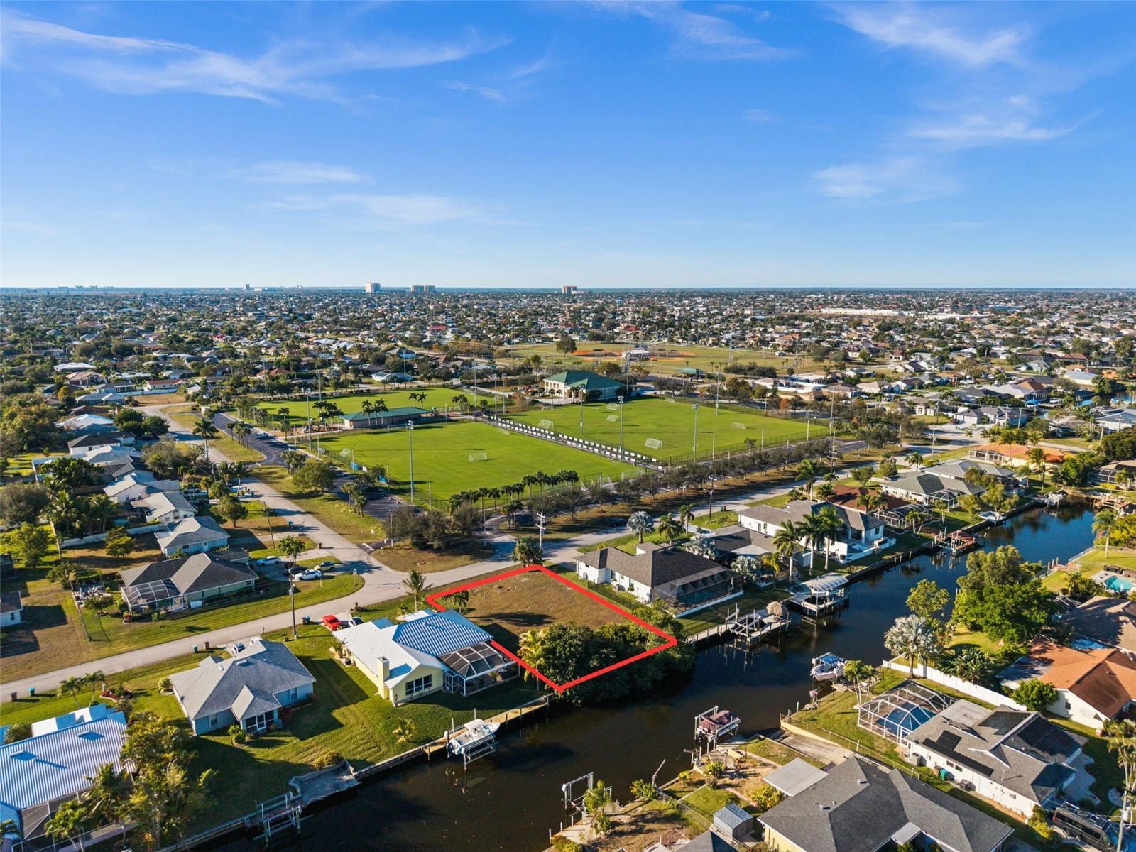 Build your dream home on this exceptional single-family Gulf access lot located at 241 SW 40th Street in the sought-after Pelican neighborhood of Cape Coral. This established community is known for its beautiful homes, peaceful streets, and convenient access to boating, recreation, and everyday amenities.

Situated on a Gulf access canal, this property offers the perfect opportunity to enjoy boating, kayaking, and fishing right from your own backyard. The lot is cleared, level, and ready for construction, making it easy to bring your vision to life. Even better, city water and sewer are already in place, and all assessments have been paid—providing significant savings and a valuable advantage for future homeowners.

One of the property's most unique features is the soccer field and park located directly across the street, offering open views and immediate access to outdoor recreation while still maintaining a sense of privacy. Whether you enjoy morning walks, youth sports, or simply having green space nearby, this location delivers a rare combination of waterfront living and neighborhood amenities.

Zoned for single-family residential use and with no HOA restrictions, this property provides flexibility for a primary residence, seasonal retreat, or future investment opportunity.

Conveniently located near shopping, dining, schools, and all that Southwest Cape Coral has to offer, this is an incredible opportunity to secure a Gulf access lot in one of the city's most desirable neighborhoods.

Don't miss your chance to build the Florida waterfront lifestyle you've been dreaming of in Pelican.