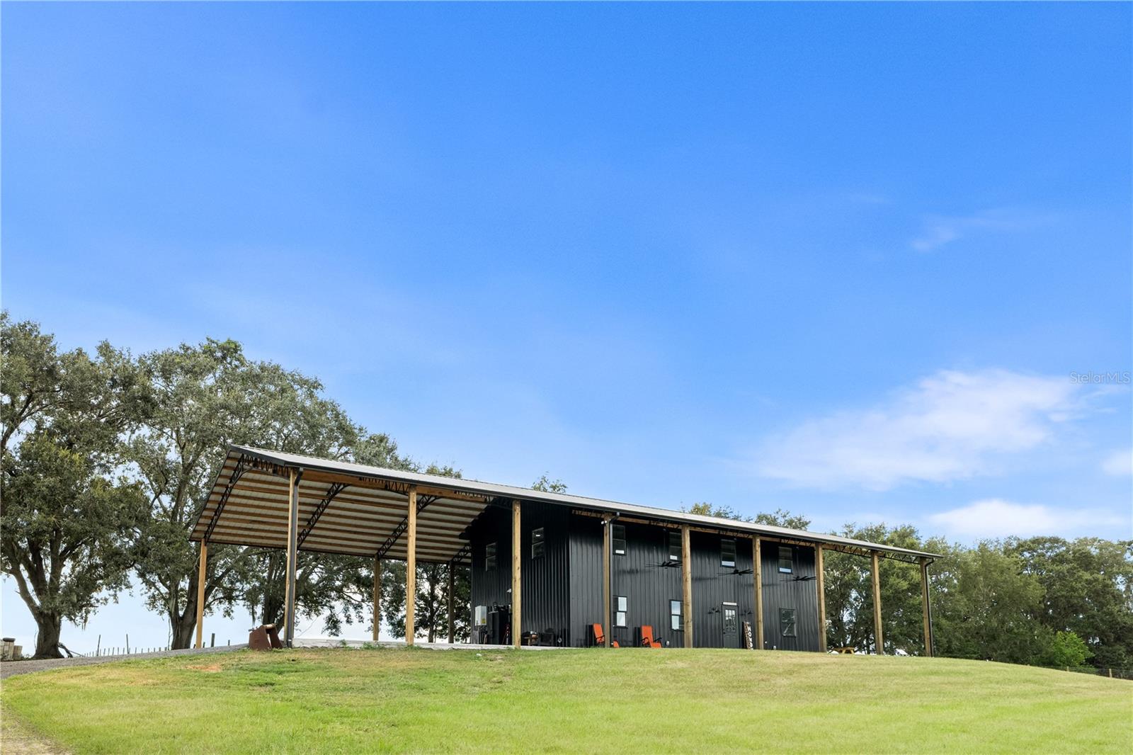 Welcome to one of the most unique settings you will find in this area. Set on a hilltop and spanning 19.34 acres, this property offers a level of privacy, elevation, and views that are hard to come by in Marion County. From the moment you arrive, you can feel the difference, wide open pasture, expansive views, and a quiet that makes you want to slow down and stay awhile.

Located approximately 20 to 25 minutes from the World Equestrian Center, as well as close to Williston and nearby trail systems, this property offers a rare opportunity for someone looking for space, flexibility, and the ability to create something of their own in a prime equestrian area.

The land is already set up with perimeter and cross fencing, a private pond, and a 40x60 pole barn with a 20x60 lean to, providing a strong foundation for horses, livestock, or equipment.

There is a newly constructed structure on the property featuring 3 bedrooms, 2 bathrooms, a loft space, and approximately 3800 square feet under roof, offering flexible use depending on your needs.

Inside, the space has a modern industrial feel with vaulted ceilings, exposed steel trusses, and an open layout filled with natural light, giving it a character that stands apart from more traditional properties.

Whether you are looking to bring your horses, start a farm, or invest in acreage with long term potential, this property offers space, setting, and opportunity in a location that continues to grow in demand.