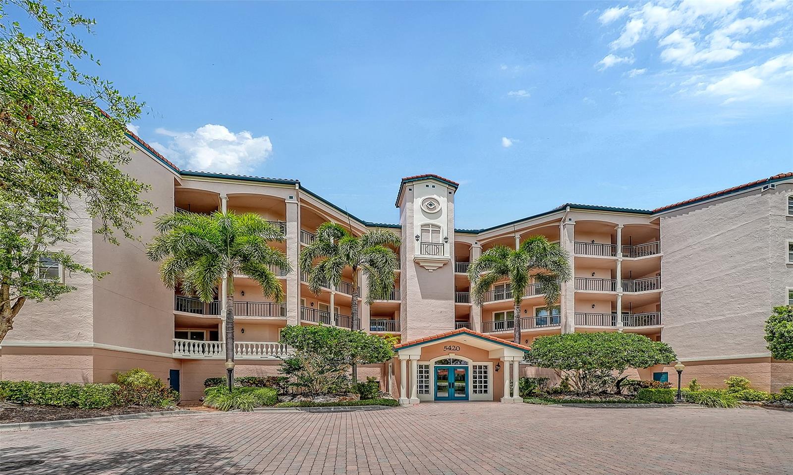 Perched atop the building, this exceptional penthouse offers sweeping, unobstructed views over a lush green preserve, complemented by enticing peek-a-boo glimpses of the Intracoastal Waterway. Enjoy these panoramic vistas from the living room, primary bedroom or a stunning glassed-in seating area. This unique space captures expansive scenery while inviting gentle coastal breezes, creating a seamless blend of indoor comfort and outdoor beauty. The kitchen features a cozy breakfast nook, perfect for starting your day. The spacious primary suite includes a large walk-in closet, separate vanities, a walk-in shower with a rainhead, plus a semi-private water closet. The versatile den or study is outfitted with a closet, offering flexibility, and can easily be converted into a third bedroom to suit your needs. Located behind the gates of The Landings, this maintenance-free residence is ideal as a full-time home or seasonal getaway, offering both tranquility and convenience. Just minutes from vibrant downtown Sarasota, you’ll have easy access to an array of dining, shopping and cultural attractions, while world-famous Siesta Key Beach is only a short drive away. Residents of The Landings enjoy an impressive array of amenities within this private, gated community. Take advantage of Har-Tru tennis courts, a fitness center and an active clubhouse. The junior Olympic-sized swimming pool provides a place to relax or stay active, while kayak storage and a launch area make it easy to explore the nearby Intracoastal Waterway. A scenic nature trail further enhances the community’s appeal, offering peaceful surroundings and direct access to the water. This penthouse delivers an exceptional lifestyle defined by natural beauty, comfort and convenience.
