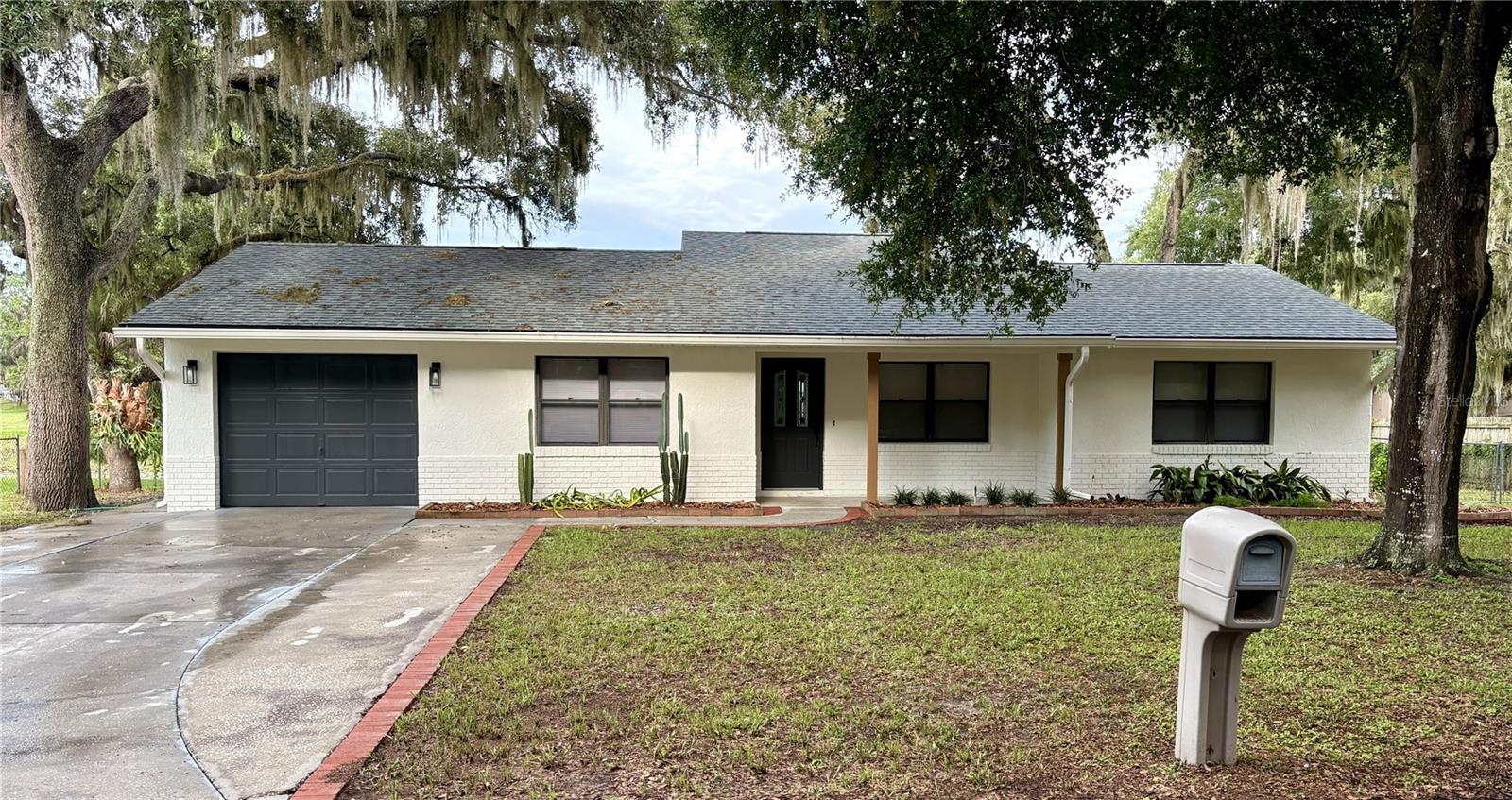 BANG FOR YOUR BUCK! That's what you're getting with this NEWLY RENOVATED concrete block home. Tastefully done and pretty neutral so that you can add your own personal touches. Let me also mention that it has a LAKEFRONT VIEW! Nestled high upon the banks of a small lake teeming with wildlife, you can watch the native birds as they stroll the banks and bask in the sun, or you could slip down to the water and cast a line. Either way you'll love the view from the nicely sized fenced back yard. If sunrises are your thing, you can sit out in the Florida room in the ac or with the windows open and enjoy a cup of coffee and watch the sun come up over the trees to the East.  Now let's talk about this ABSOLUTELY FANTASTIC home!! This home is just about as close to new as you can get. Newly renovated, nearly everything in the home is brand new! Starting at the top, the roof is only 3 years old, exterior paint is new, exterior doors are new, inside you'll find all new flooring throughout the entire home, fresh paint on all the walls and ceilings, both bathrooms are completely brand new from the floor to the ceiling as well, including toilets and sinks, tub/shower, fixtures etc. All bedrooms have new bedroom and closet doors and shelving. Every window also has a new blind. What about the kitchen you ask? Well... the kitchen has all brand new cabinets and granite countertops, new pantry door and shelving, and for reliability ALL STAINLESS APPLIANCES ARE BRAND NEW AND CONVEY!!! That's right, new fridge, range, range hood/microwave, dishwasher, and garbage disposal. Just off the kitchen you can sit and enjoy the lake view from the bay windows. The indoor laundry room is a HUGE convenience as well. And you guessed it, everything in there is new also! With a cute barn style, sliding door entry there's no interference with your breakfast nook area. And new shelving and cabinets for storage with granite countertop matching the kitchen. There's also direct access to the garage from the laundry area as well. I also NEED TO TELL YOU that there's no need to "sweat" about this Florida summer heat. BECAUSE... YEP! BRAND NEW HVAC!!! Every light fixture, fan, and outlet are new as well. So, schedule a showing QUICK!! This home won't last long with all that it has to offer at this price.