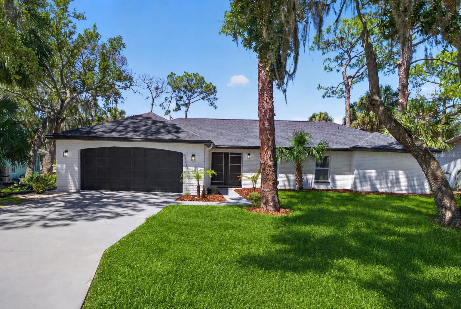 SOME BUY A WATERFRONT HOME. OTHERS BUY THE REASON THEY NEVER WANT TO LEAVE. It starts with mornings by the pool as the canal comes alive. By afternoon, you're idling out from your private dock toward the open Gulf with NO BRIDGES slowing the journey. By evening, you're back home just in time to watch another spectacular sunset while dolphins and manatees drift past your backyard. THIS IS THE FLORIDA LIFESTYLE THAT'S WORTH CHASING. Positioned on an incredible 101 FEET OF DEEP SAILBOAT WATER in Gulf Harbors Woodlands, this fully renovated waterfront estate offers over 2,500 square feet of refined coastal living where every detail was designed to make the water part of everyday life. From the moment you enter, your eyes are drawn through the open living spaces to the sparkling pool and canal beyond. The chef’s kitchen anchors the home with an oversized quartz island, premium Samsung appliances, custom cabinetry, and seamless connection to two dining areas and multiple living spaces, making entertaining effortless as conversations flow naturally from the island to the lanai. Multiple sliding doors blur the line between indoors and out, filling the home with natural light and breathtaking waterfront views. The split-bedroom design provides exceptional privacy. The primary suite serves as its own retreat with direct pool access, panoramic water views, a spa-inspired bath, and a generous walk-in closet. On the opposite side of the home, two oversized guest bedrooms share a thoughtfully designed Jack & Jill layout where EACH BEDROOM FEATURES ITS OWN PRIVATE VANITY AND WATER CLOSET, SHARING ONLY THE SHOWER. A third full bath is perfectly positioned for pool guests. Step outside to an oversized screened lanai surrounding the beautifully refinished pool before continuing to your private dock complete with BOAT LIFT, WATER, AND ELECTRIC HOOKUPS. Spend weekends fishing, scalloping, paddleboarding, kayaking, island hopping to Anclote Key, relaxing at the local sandbars, or cruising to waterfront restaurants—all just minutes from your backyard. A COMPLETE PERMITTED RENOVATION includes a NEW ROOF, HVAC, WINDOWS, HURRICANE SHUTTERS, PORCELAIN TILE THROUGHOUT, DESIGNER LIGHTING, LUXURY KITCHEN AND BATHS, and premium finishes from top to bottom. Residents enjoy a private community boat ramp, waterfront pool, and tennis courts, with optional memberships to the Gulf Harbors Beach Club and Gulf Harbors Yacht Club. The Beach Club offers private white sand beaches, tiki huts, grills, volleyball, and unforgettable Gulf sunsets, while the Yacht Club features waterfront dining, a full-service bar, social events, and an active boating community. THE VIEW WILL CATCH YOUR ATTENTION. THE LIFESTYLE WILL MAKE YOU STAY.