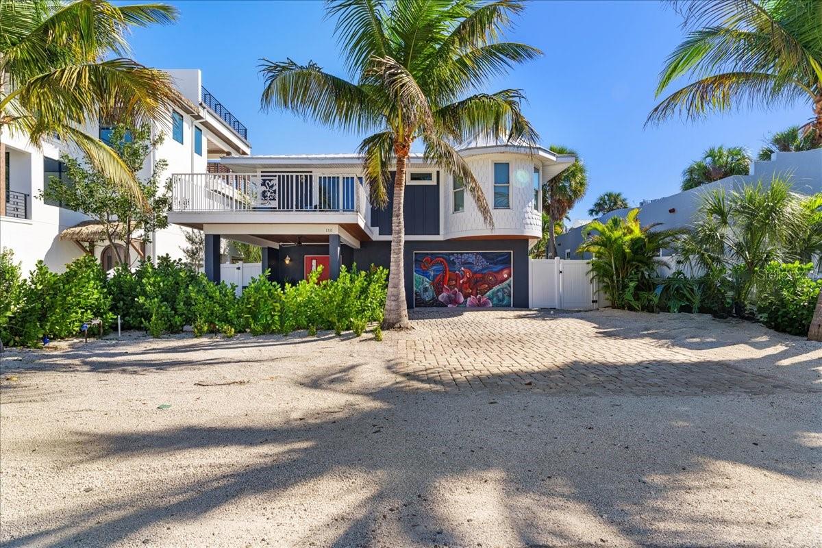 AMAZING HOME "BLUE CRUSH" ONLY 4 HOUSES TO THE BEACH!!! LOCATIONS LIKE THIS ARE RARELY AVAILABLE WEST OF GULF DRIVE! IT DOES NOT GET BETTER THAN THIS! STEPS TO BEACH AND THE WATERFRONT LIFESTYLE! This exquisite retreat offers the perfect blend of luxury, comfort, and convenience. As you step inside, you'll immediately be drawn to its enticing features. This home has been updated with no expense spared to bring it up to todays standards. Hosting gatherings becomes a delight with the updated and fully equipped kitchen, ensuring seamless meal preparation and service, especially for those poolside occasions with family and friends. The interior of this 3 bedroom, 3 bathroom haven is designed for both comfort and style. The living area, adorned with pocket sliding doors, seamlessly connects to a spacious outdoor deck, creating a harmonious indoor-outdoor living experience. Picture evenings spent watching TV, feeling the gentle breeze, and sipping drinks on the balconies. The kitchen, featuring granite countertops and stainless-steel appliances, is a chef's delight, making cooking a pleasure. An outdoor dining table on the deck provides an ideal setting for enjoying your culinary creations. The sunlit primary bedroom, with a private balcony and a luxurious ensuite bathroom, provides a dreamy retreat. Additional bedrooms include a second bedroom with balcony access and ensuite , a third bedroom with pool deck access, and an additional space could serve as a fourth bedroom, featuring bunk beds. The tropically landscaped backyard is a haven for relaxation. The stunning pool, complete with a sun shelf, invites you to bask in the Florida sun, while the expansive covered patio provides a shaded retreat for family conversations, refreshments, and games. Prime location allows for easy exploration of Pine Avenue's boutiques and culinary delights. Beach access is just a few steps away, offering warm turquoise waters and soft sand. Take a leisurely stroll to Anna Maria Island City Pier or enhance your stay with activities like chartering a fishing trip, a sunset cruise, or paddleboarding through the mangroves. Property is currently a successful rental and has forward bookings in place. Perfect for a second home or investment property. Experience the epitome of island living!