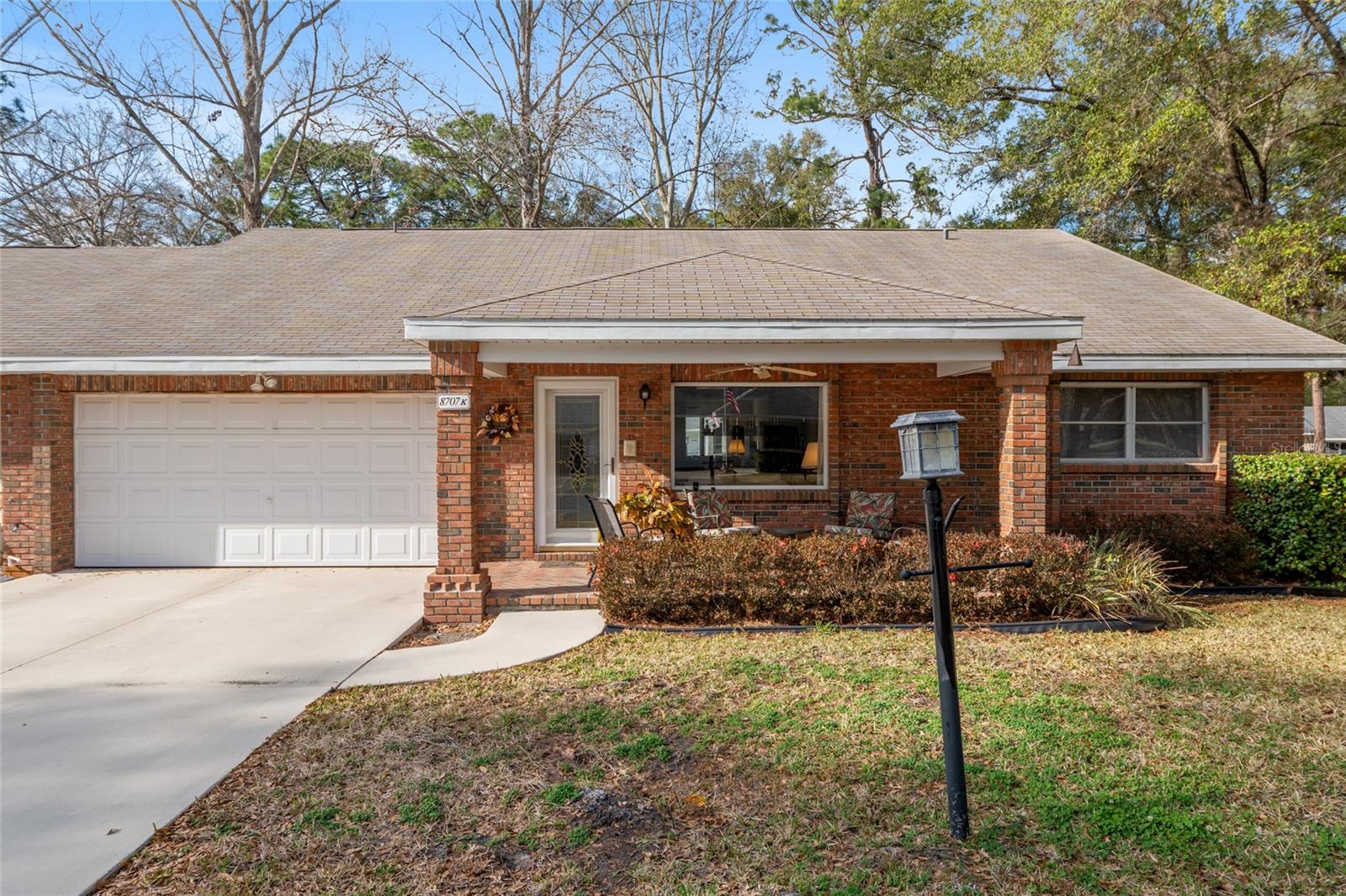 SELLER FINANICING WITH ATTRACTIVE TERMS AVAILABLE! Located in the Village of Americana in the gated community of On Top of The World, this end unit was custom designed for a private client. It offers an enlarged master bedroom/sitting area with French doors, guest bedroom, 2 bathrooms, upgraded kitchen with granite counter tops, two pantries, family room, wood burning fireplace, a spacious sun room with two large new energy efficient windows that provide a clear view of the outside while maintaining privacy, an indoor laundry, a 2 car garage for a total of 2,018 sq. feet under HVAC. Additional amenities include a built in trash compactor, seven ceiling fans, three
ceiling solar tubes for additional light, a new Trane HVAC system installed February 2025, a new Whirlpool 21.4 cubic foot refrigerator/freezer installed June 2025, and remodeled walk in showers with glass sliding doors. This home includes an Energy Wise upgrade from HCW to Horizon 4G. Constructed with 16 inch thick brick exterior walls, this home offers durability and efficiency.
