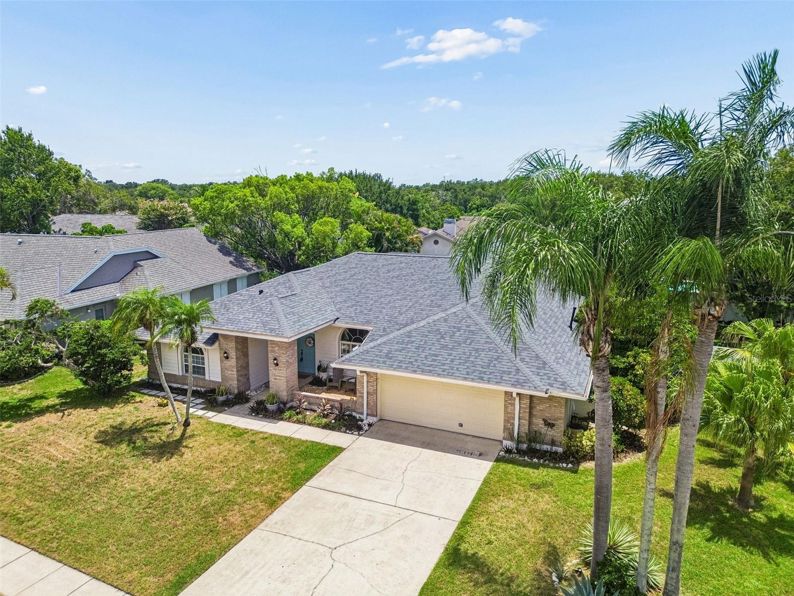 OPEN HOUSE Sunday 07/12 12PM - 2PM. Welcome to this beautifully maintained 4-bedroom, 3-bath pool home in the highly desirable Pipers Meadow community of Palm Harbor. Situated on an OVERSIZED CORNER LOT of 1/3 of an ACRE, this spacious residence offers 2,363 square feet of thoughtfully designed living space with a sought-after three-way split floor plan. Step inside to find elegant hardwood flooring, plantation shutters, crown molding, and abundant natural light throughout the formal living and dining areas. The open-concept kitchen overlooks the inviting family room, creating the perfect space for everyday living and entertaining. French doors from both the living room and family room lead to a large screened lanai featuring a sparkling pool, covered outdoor seating area, and a private, fully fenced backyard ideal for relaxing, gardening, or enjoying time with family and pets. The spacious primary suite is a true retreat with tray ceilings, French doors to the lanai, dual walk-in closets, and a luxurious ensuite bath complete with double vanities, a soaking tub, walk-in shower, and private water closet. A separate guest suite offers excellent flexibility for multigenerational living, a home office, or visiting guests with the bathroom leading out into the pool area.  Additional features include a 2-car garage, storm shutters for every window for added peace of mind, mature landscaping, and a low HOA. New Roof (2023) New AC (2022) New Water Heater (2021) Garage Door Hurricane Proof and FLOOD ZONE X! Located in one of Palm Harbor's most sought-after neighborhoods, this home is zoned for top-rated schools, including Palm Harbor University High School, and is just minutes from the Pinellas Trail, Gulf beaches, shopping, dining, medical facilities, and everything Palm Harbor has to offer. This exceptional home offers the perfect combination of space, comfort, and location—an outstanding opportunity to enjoy the Florida lifestyle.
